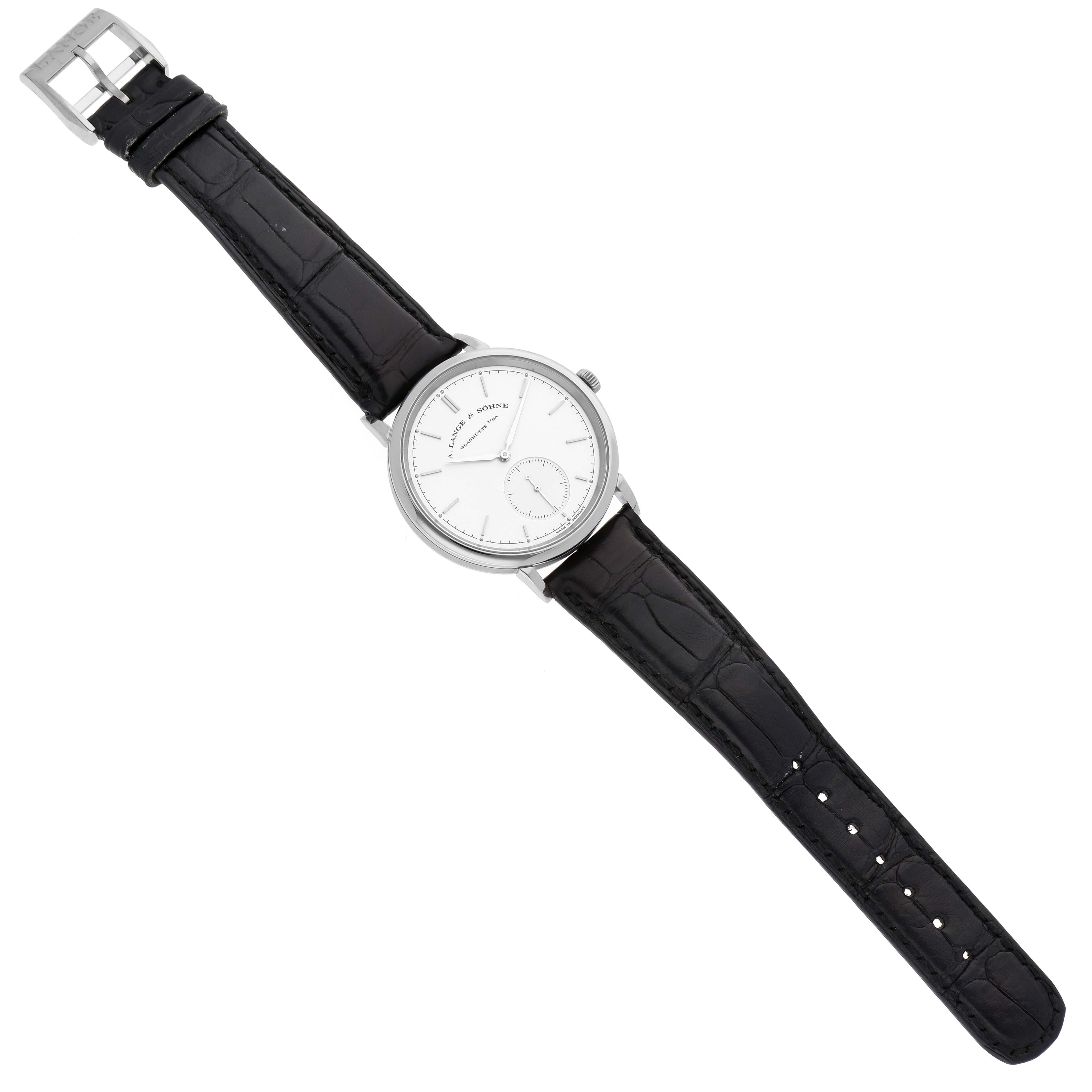 This image shows the A. Lange 
Sohne Saxonia 380.026 Men
s White Gold Silver Dial watch from a top-down angle, displaying its face, case, and black leather strap.