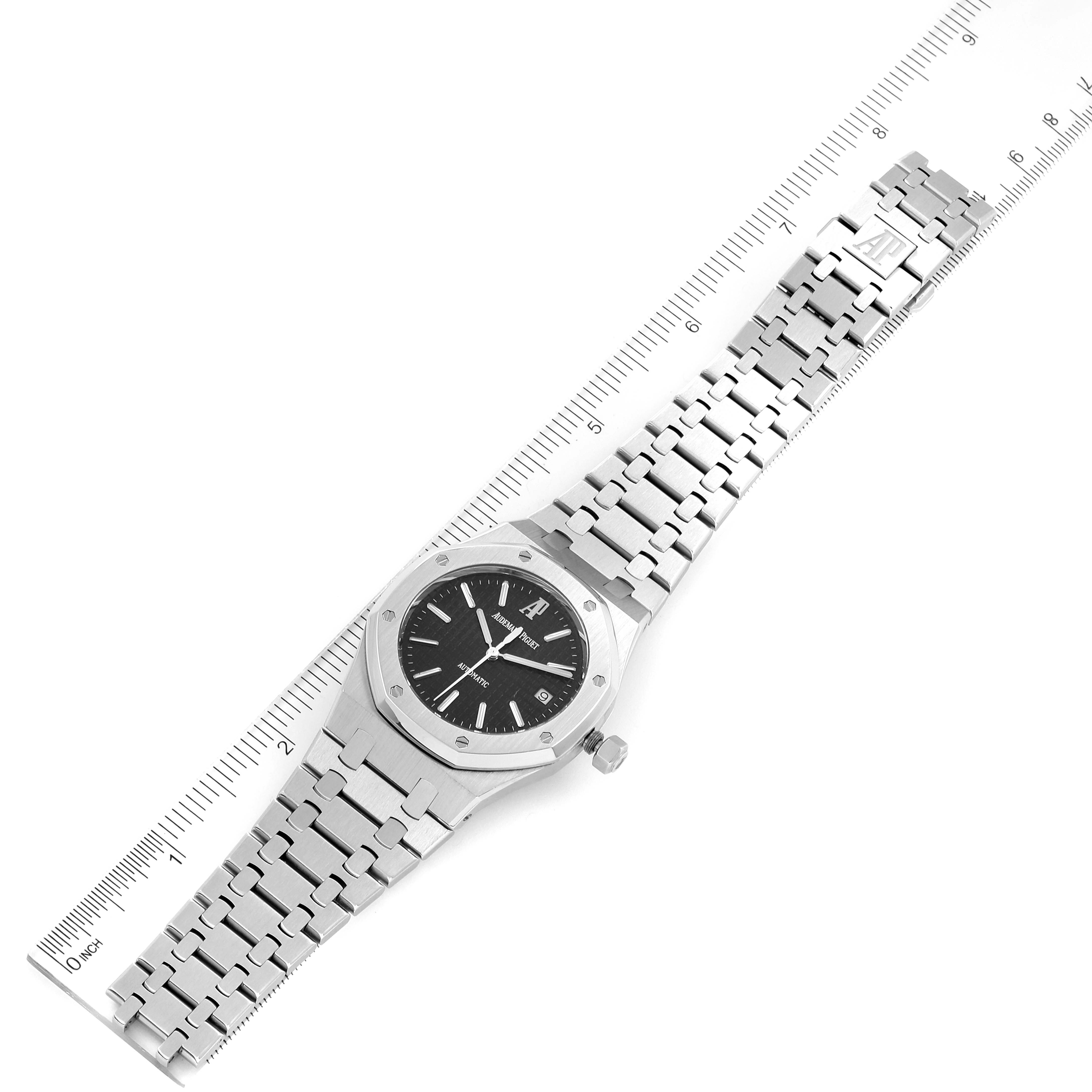 The image shows a top-down view of an Audemars Piguet Royal Oak 15300ST.OO.1220ST.03 Men's Stainless Steel Black Dial 15300ST.OO.1220ST.03 Men's Stainless Steel Black Dial watch with a ruler beside it.