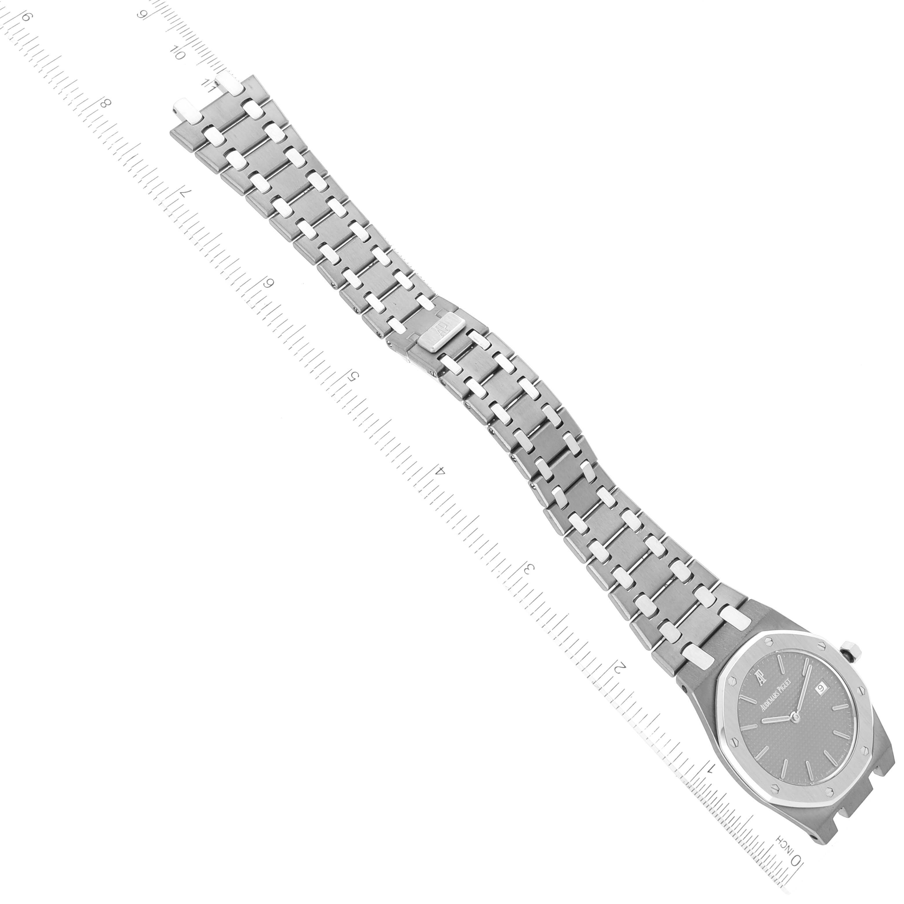 This image shows the Audemars Piguet Royal Oak 56175TT Men's Stainless Steel Grey Dial 56175TT Men's Stainless Steel Grey Dial watch from an angled top view, highlighting the face, bezel, and bracelet against a measuring ruler.