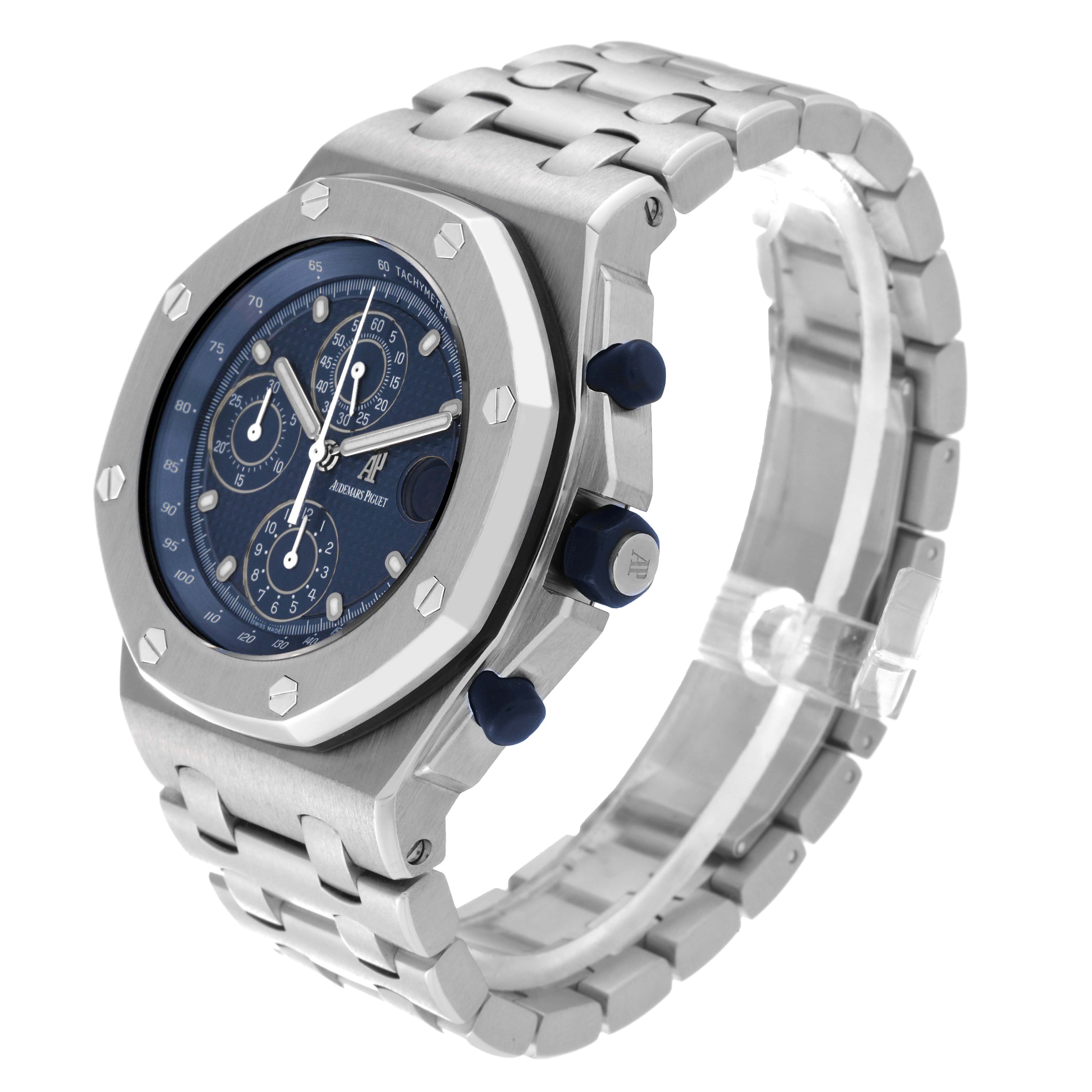 The image shows an Audemars Piguet Royal Oak Offshore 25721ST.OO.1000ST.01 Men's Stainless Steel Blue Dial 25721ST.OO.1000ST.01 Men's Stainless Steel Blue Dial watch at a three-quarter angle, displaying the watch face, bracelet, and side buttons.