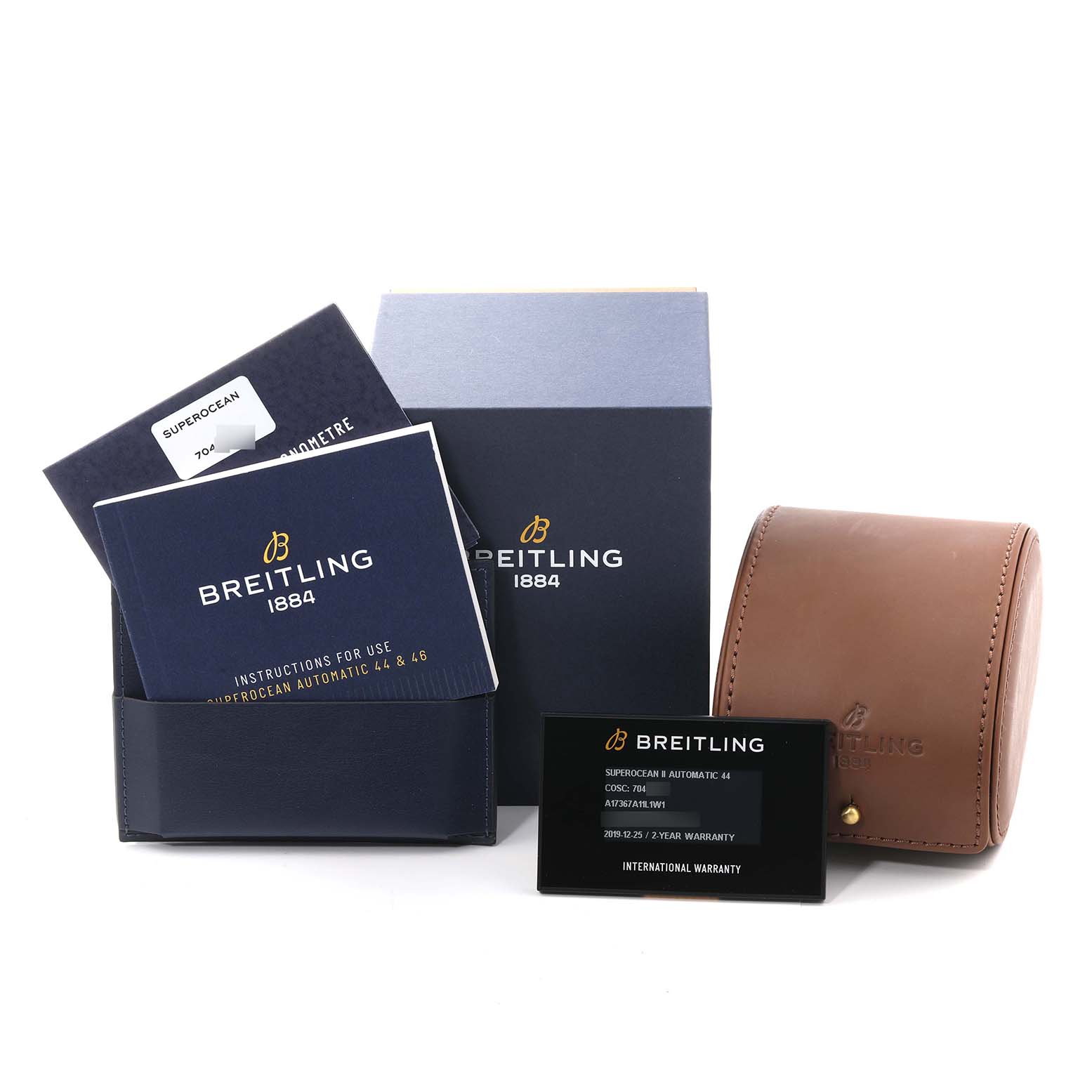 The image shows accessories for the Breitling Superocean A17367A11L1W1 Men's Stainless Steel Green Dial A17367A11L1W1 Men's Stainless Steel Green Dial watch including manuals, a warranty card, a box, and a leather case.