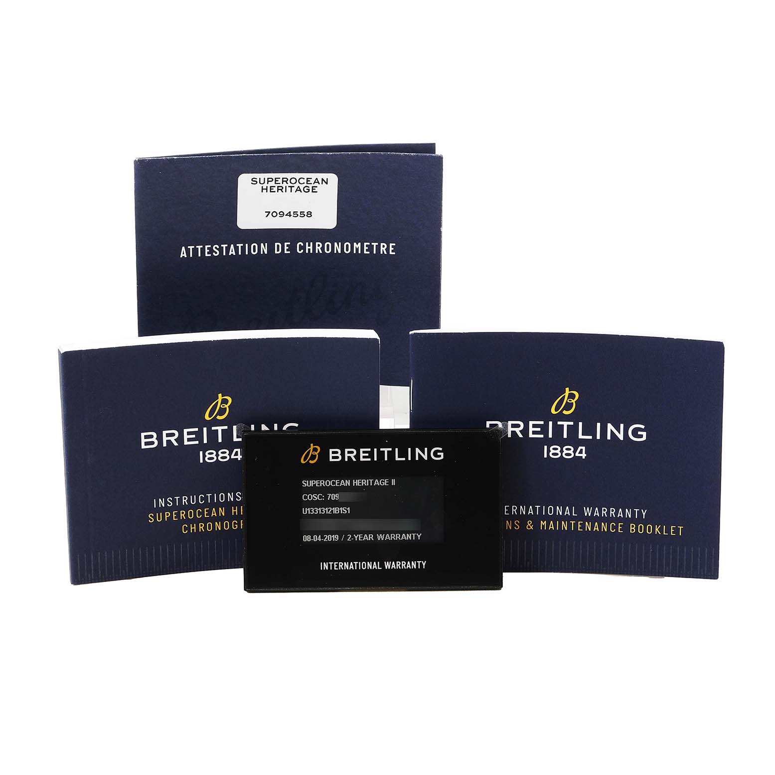The image shows Breitling Superocean U13313 Men's Stainless Steel Black Dial documentation, including booklets and an international warranty card.