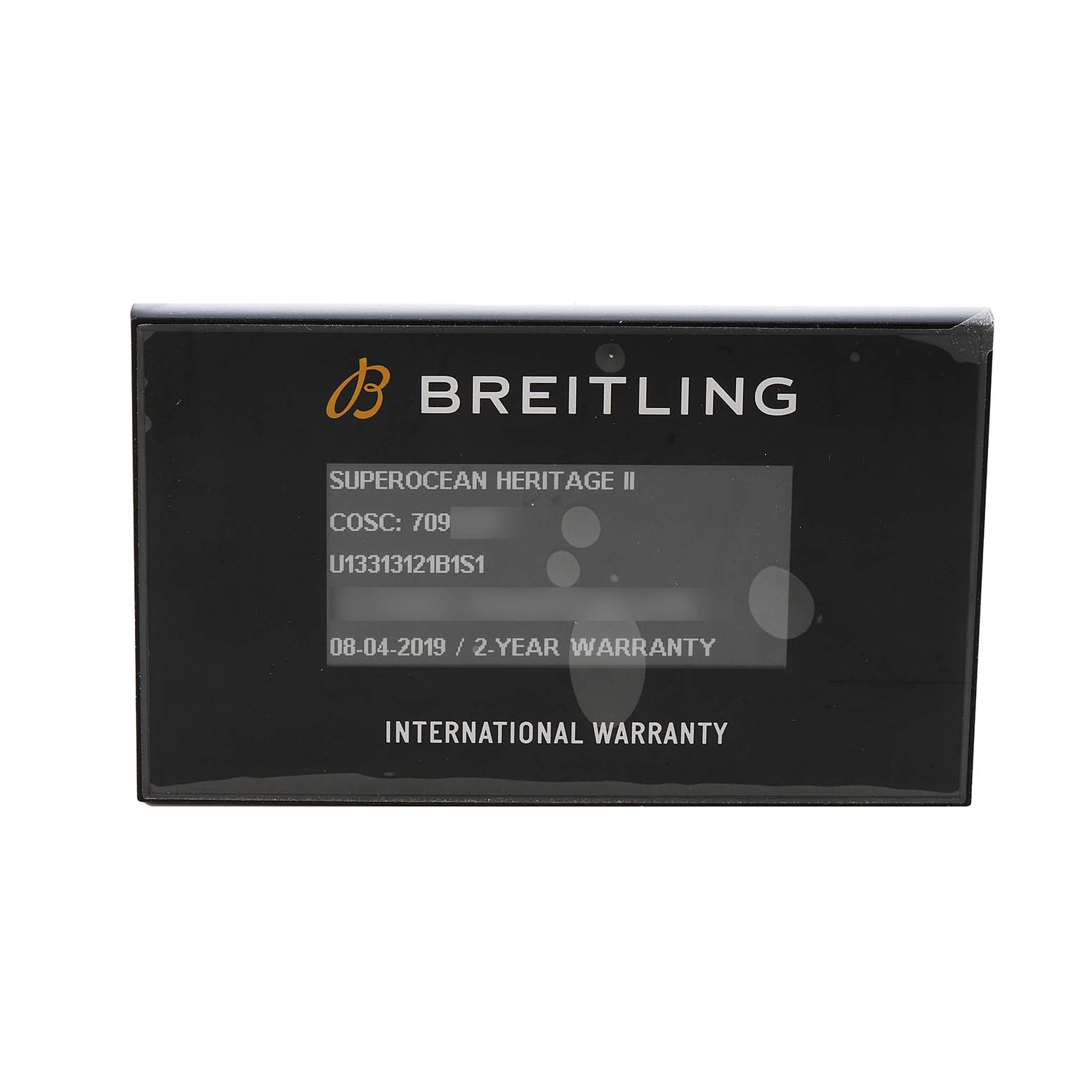 The image shows a Breitling Superocean U13313 Men's Stainless Steel Black Dial Heritage II international warranty card.