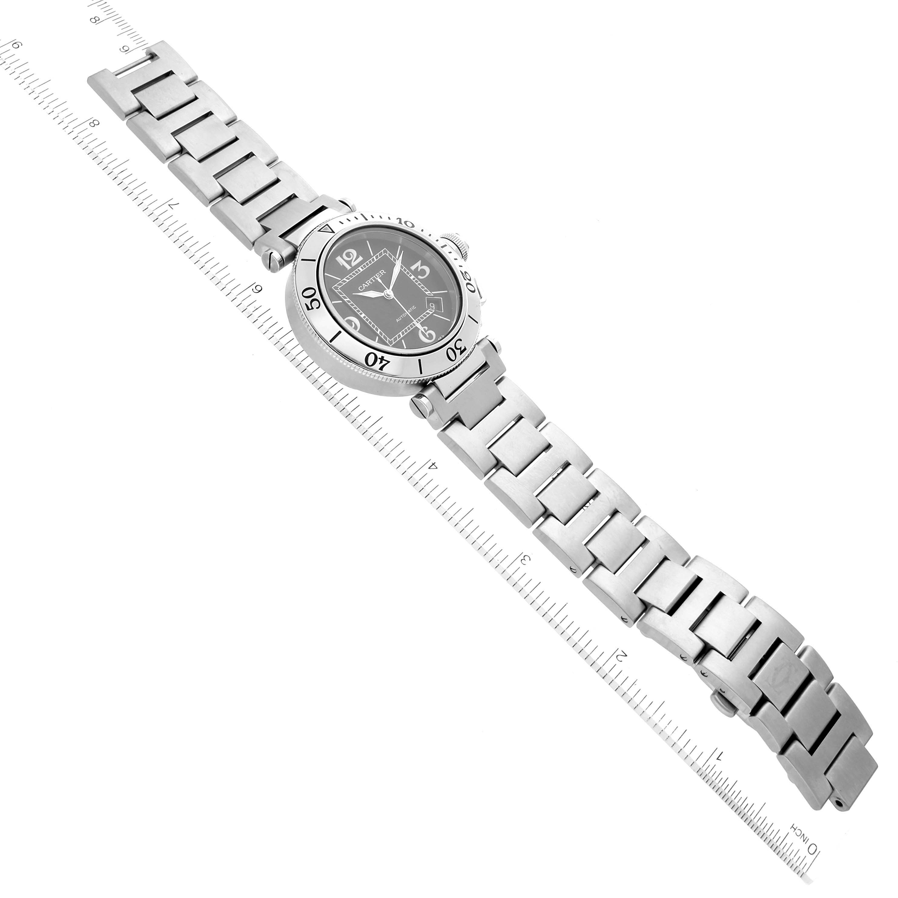 The image shows a Cartier Pasha W31077M7 Men's Stainless Steel Black Dial W31077M7 Men's Stainless Steel Black Dial watch at an angled top view, highlighting its stainless steel bracelet and bezel.