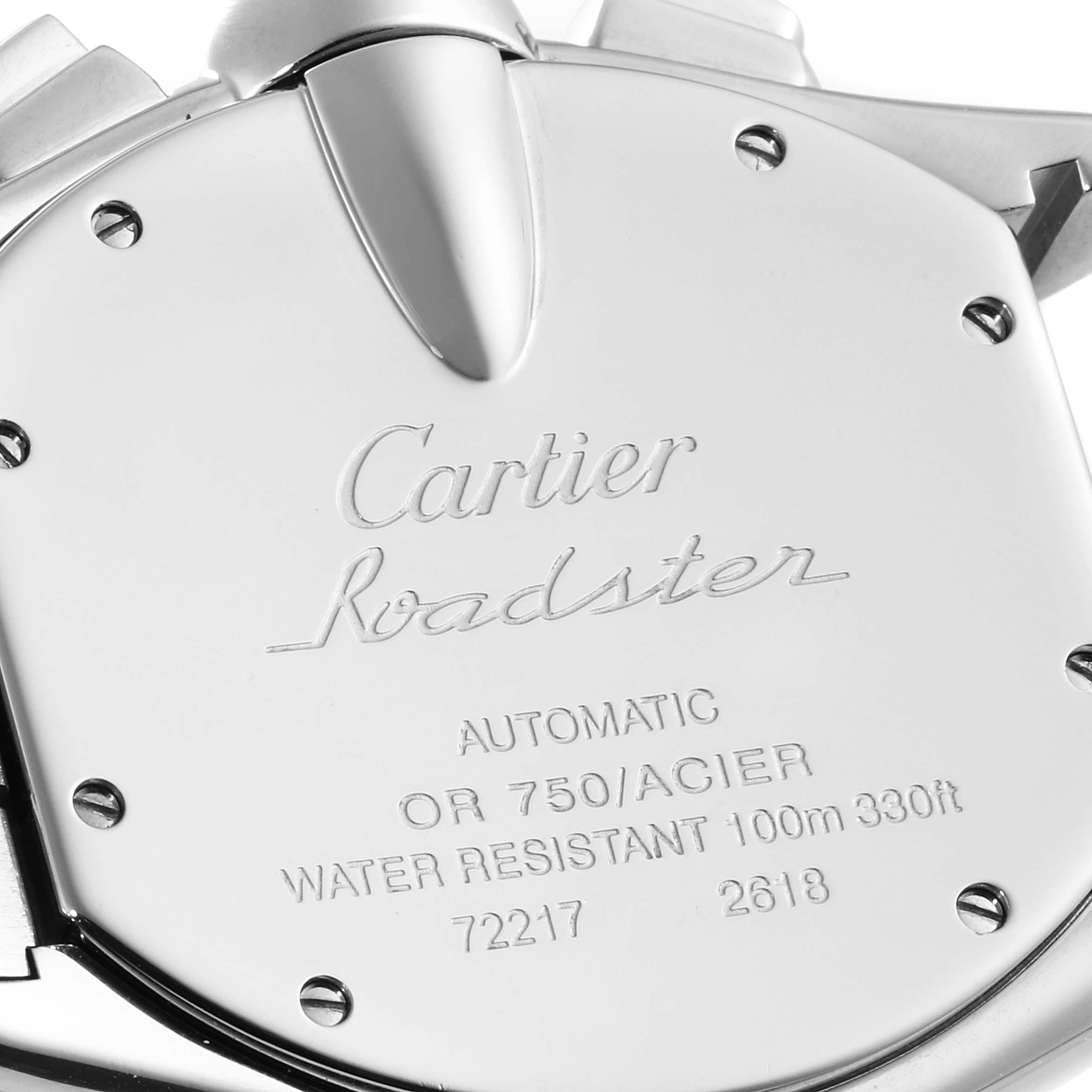 The image shows the case back of a Cartier Roadster W62027Z1 Men's Steel and Gold (two tone) Silver Dial W62027Z1 Men's Steel and Gold (two tone) Silver Dial watch with engraved details and screws.