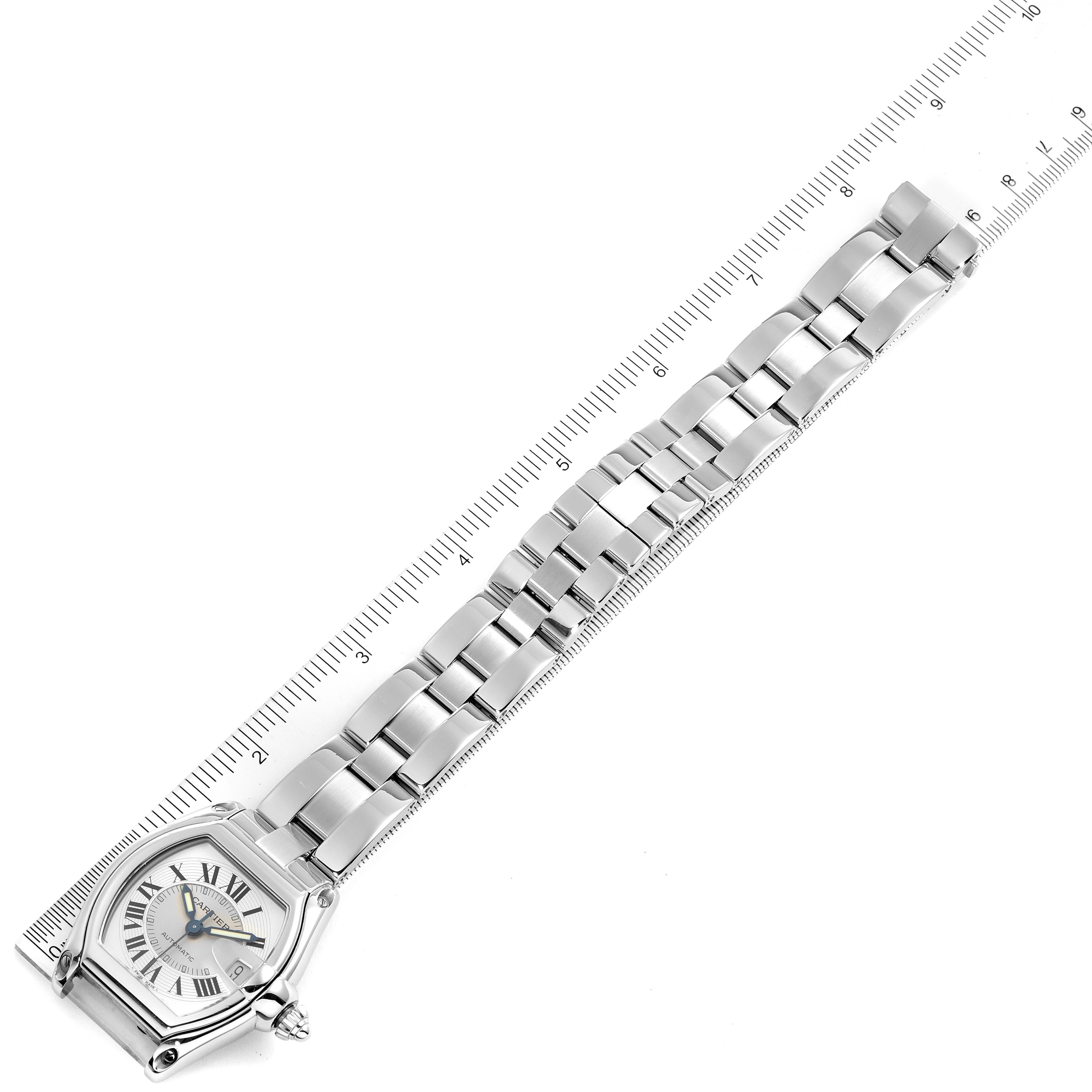 The image shows the Cartier Roadster W62000V3 Men
s Stainless Steel Silver Dial W62000V3 Men
s Stainless Steel Silver Dial watch laid flat with an attached metal link bracelet next to a ruler for scale.