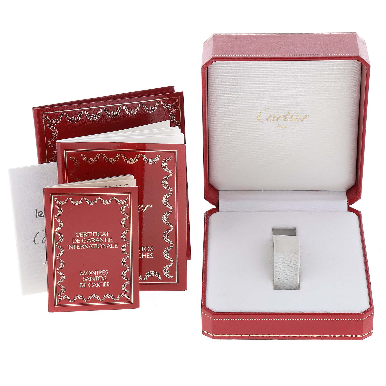 This image shows the packaging, instruction manuals, and warranty card for a Cartier Santos 1565 Women's Stainless Steel Silver Dial 1565 Women's Stainless Steel Silver Dial watch, with the empty watch box open.