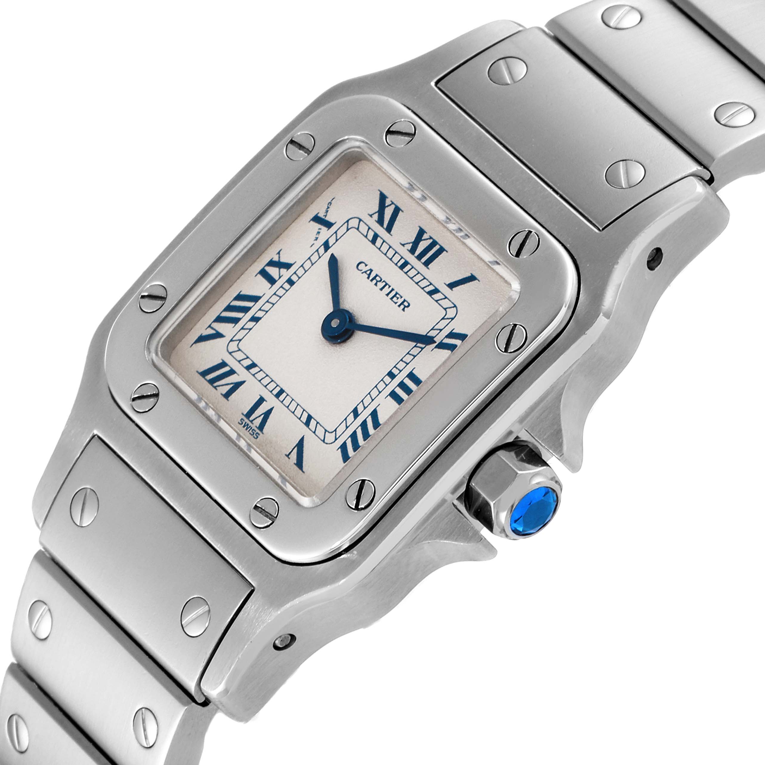 The image shows a Cartier Santos W20056D6 Women's Stainless Steel Silver Dial W20056D6 Women's Stainless Steel Silver Dial watch at an angled view, highlighting its face, bezel, crown with blue gem, and part of the bracelet.