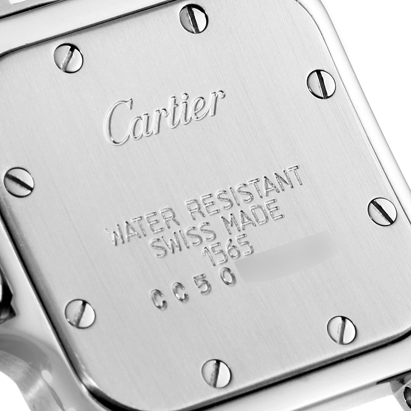 The image shows the back plate of a Santos model watch by Cartier, displaying engravings and screws.