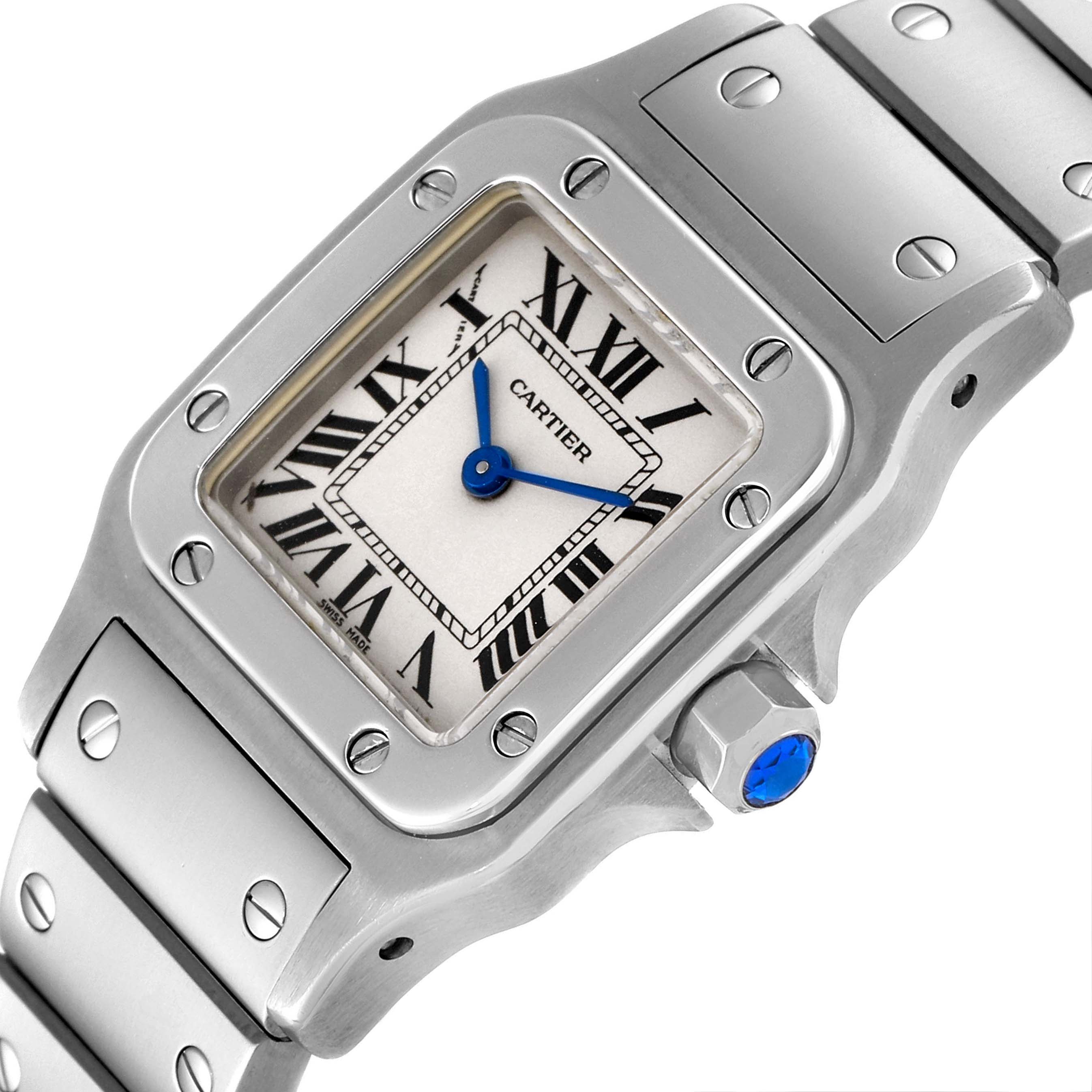 The image shows a close-up of the Cartier Santos W20056D6 Women's Stainless Steel Silver Dial W20056D6 Women's Stainless Steel Silver Dial watch face, bezel, and part of the band at an angle.