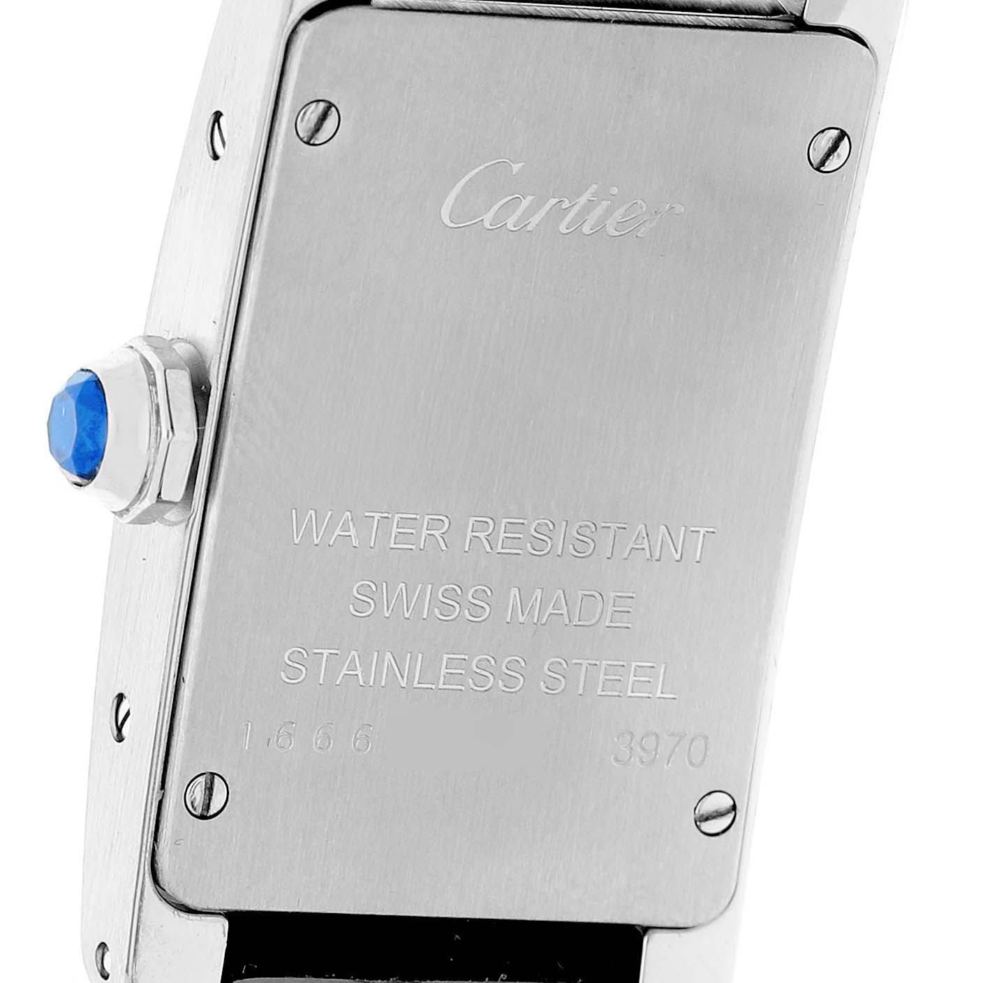 The image shows the back case of a Cartier Tank Americaine WSTA0016 Women's Stainless Steel Silver Dial watch, featuring engraved details and a blue cabochon crown.