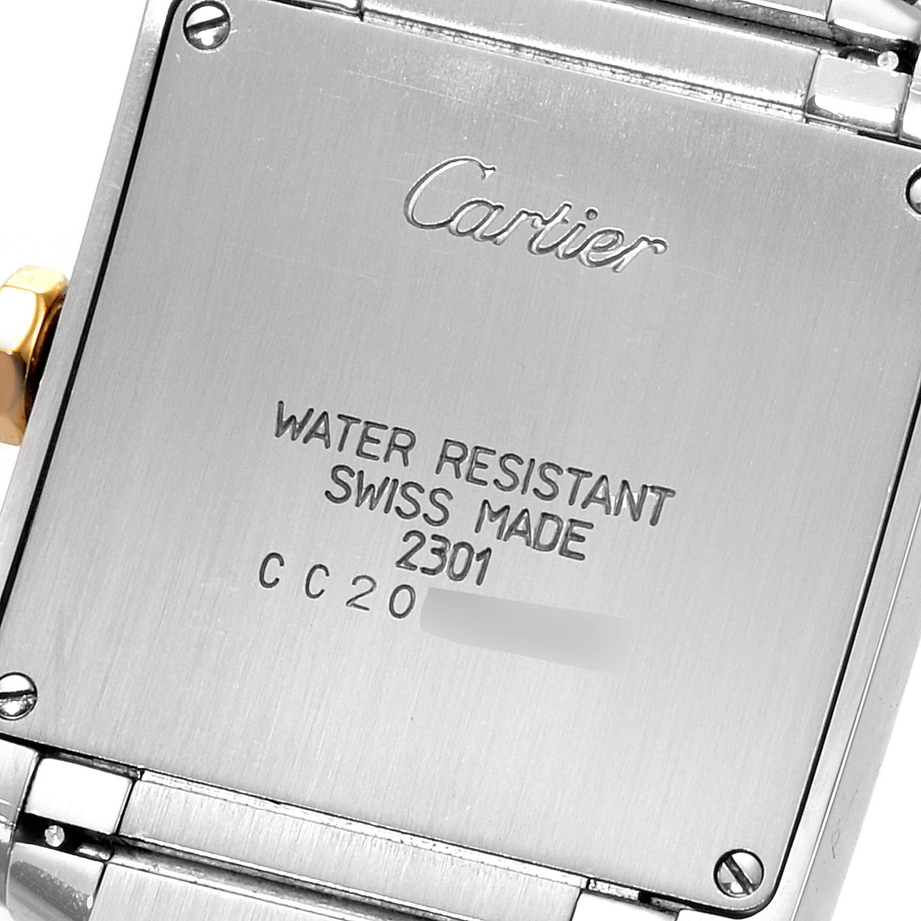 The image shows the back case of a Cartier Tank Francaise W2TA0003 Women's Steel and Gold (two tone) Silver Dial W2TA0003 Women's Steel and Gold (two tone) Silver Dial watch, highlighting the engraved details.