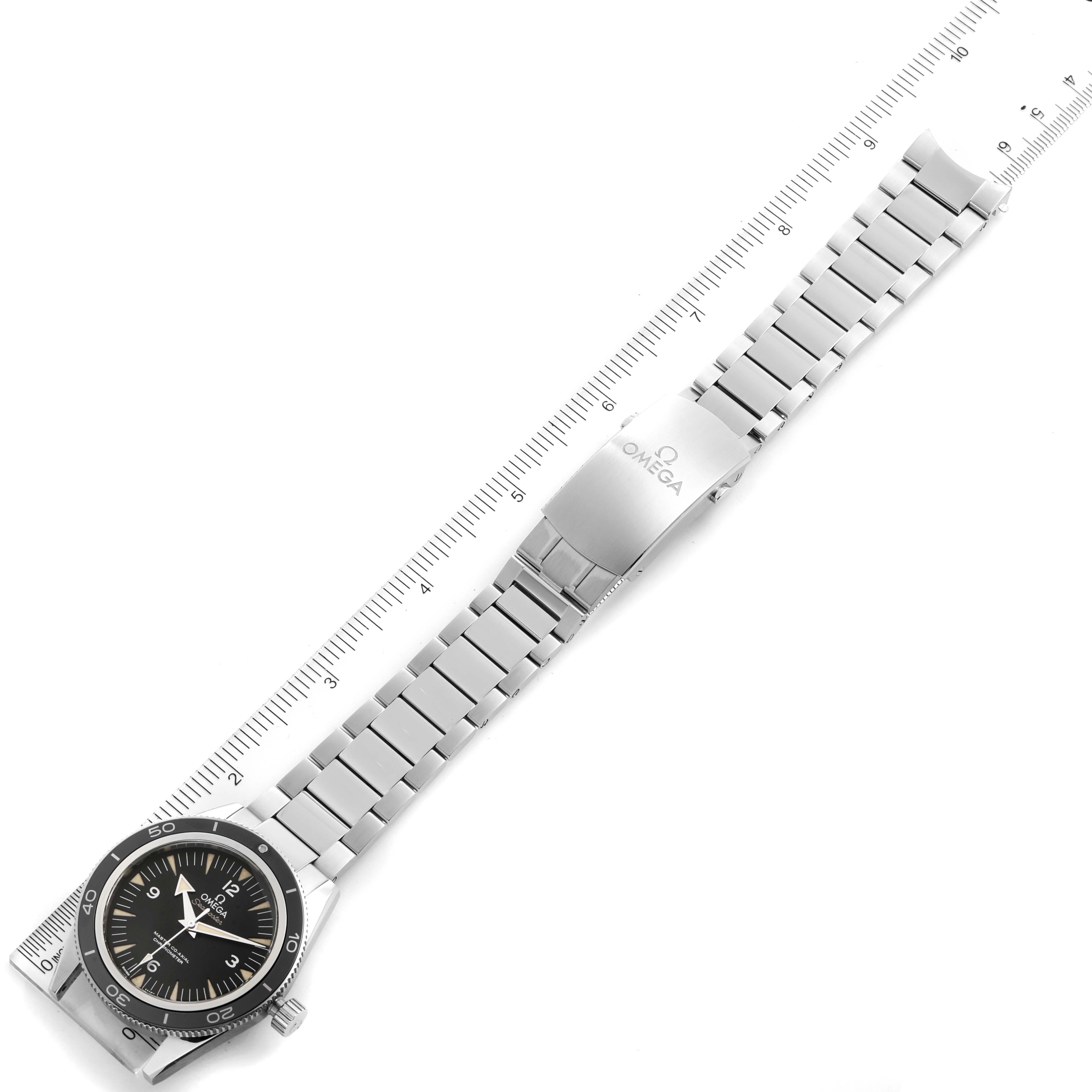 The Omega Seamaster 233.30.41.21.01.001  Men
s Stainless Steel Black Dial 233.30.41.21.01.001  Men
s Stainless Steel Black Dial watch is shown from a top-down angle, displaying its bracelet and clasp, with a ruler for size reference.