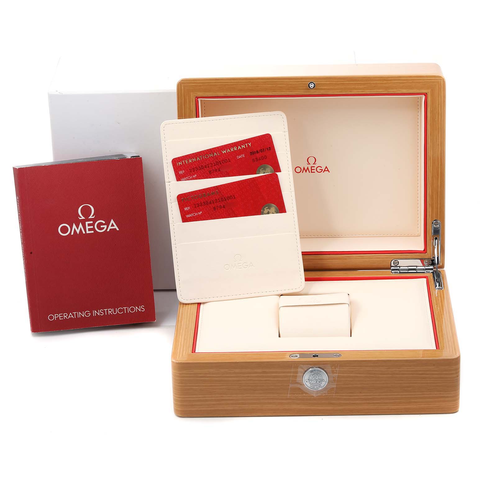 This image shows the packaging and accessories of the Omega Seamaster 233.30.41.21.01.001  Men
s Stainless Steel Black Dial 233.30.41.21.01.001  Men
s Stainless Steel Black Dial watch, including the box, operating instructions, and warranty cards.