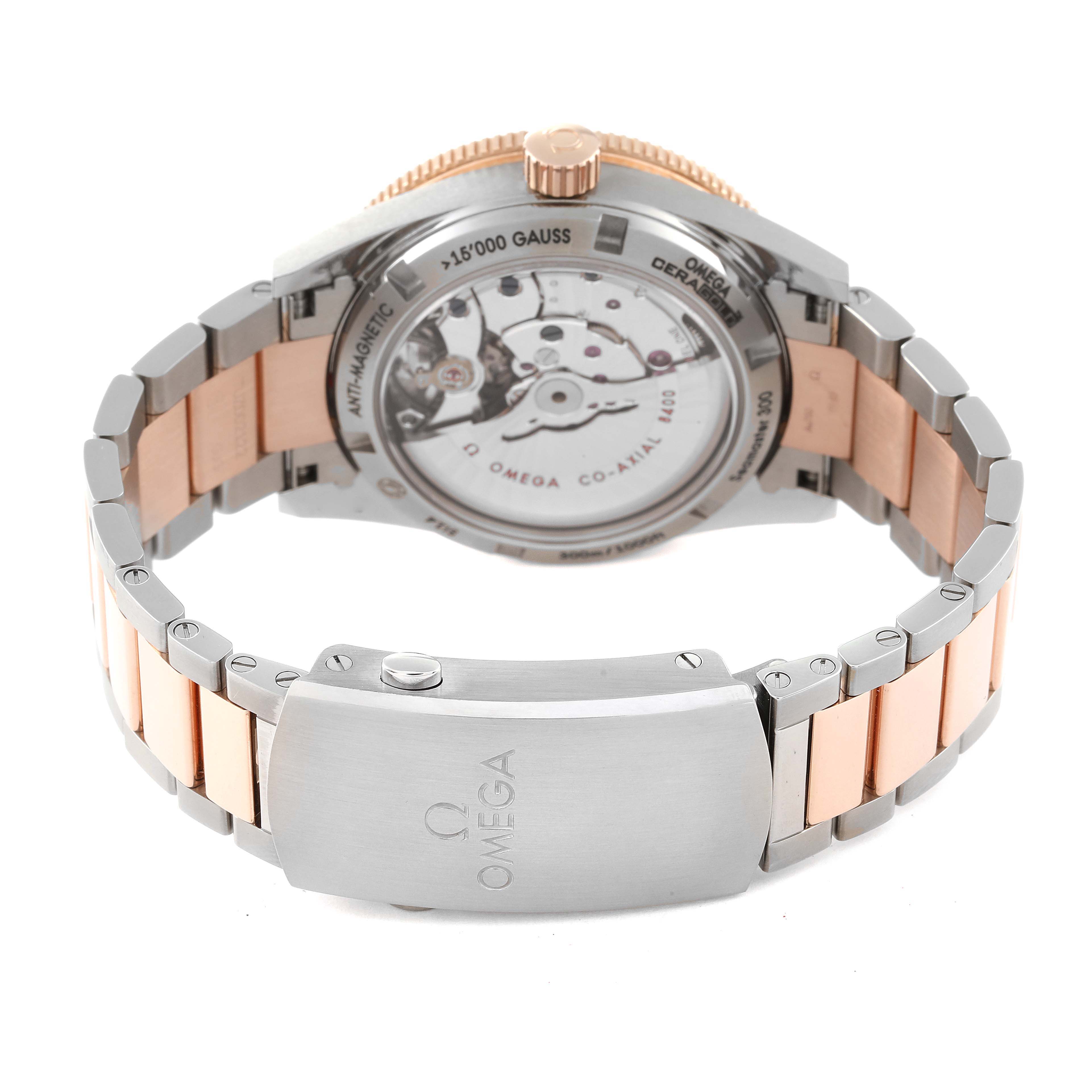 The image shows the backside and clasp of an Omega Seamaster 233.60.41.21.03.001 Men's Steel and Gold (two tone) Blue Dial 233.60.41.21.03.001 Men's Steel and Gold (two tone) Blue Dial watch, displaying the movement and part of the stainless steel and rose gold bracelet.