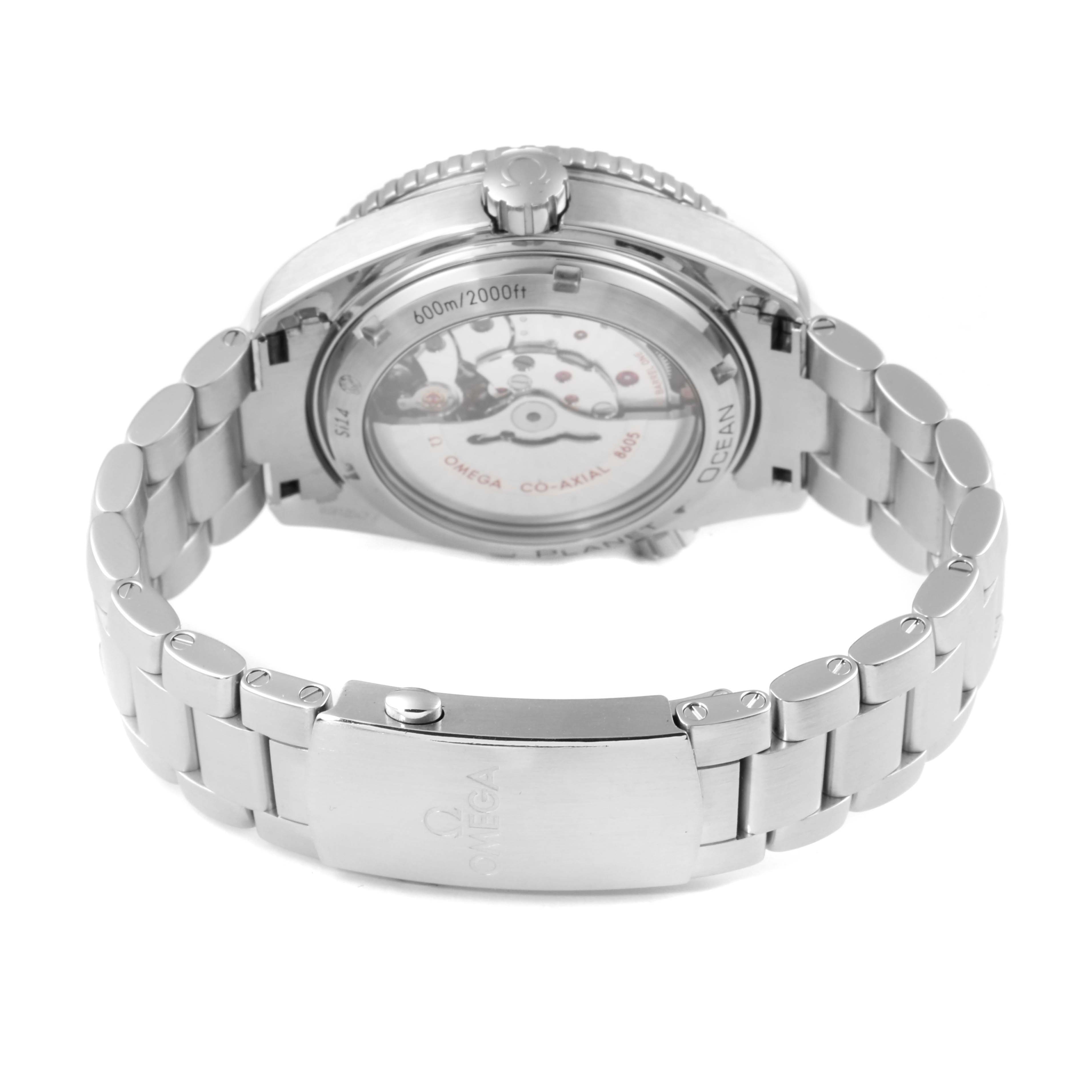 The image shows the back view of the Omega Planet Ocean 232.30.44.22.01.001 Men
s Stainless Steel Black Dial 232.30.44.22.01.001 Men
s Stainless Steel Black Dial watch, including its closed stainless steel bracelet and transparent case back.