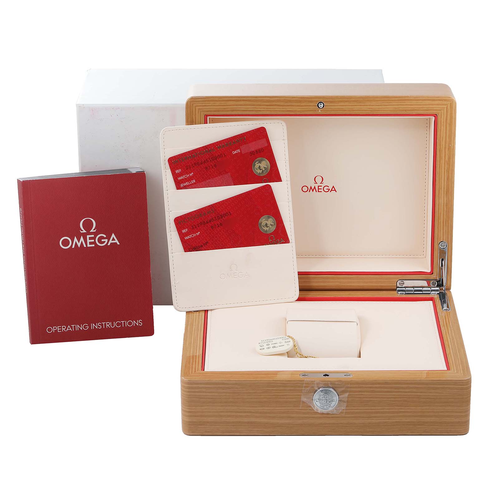 The image shows accessories for the Omega Speedmaster 311.90.44.51.03.001 Men's Titanium Blue Dial 311.90.44.51.03.001 Men's Titanium Blue Dial, including a watch box, operating instructions, and warranty cards.