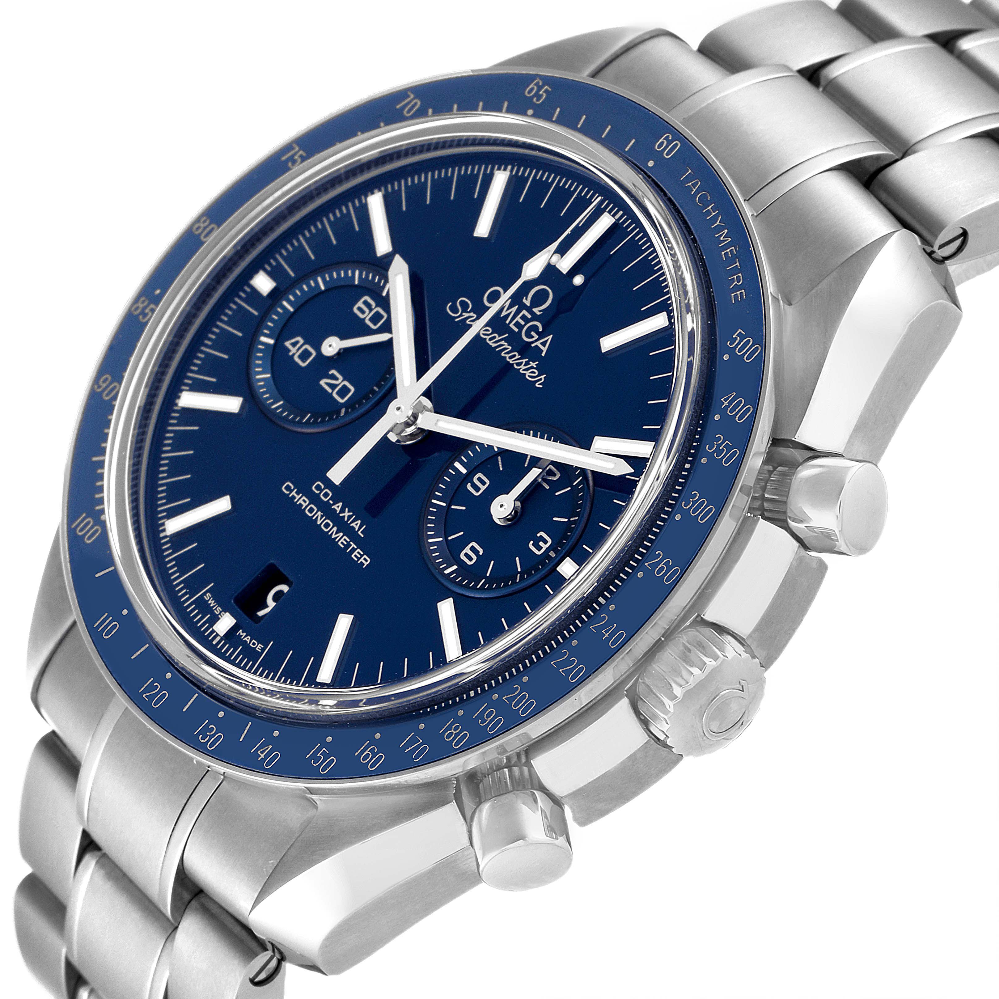 The image shows a close-up of an Omega Speedmaster 311.90.44.51.03.001 Men's Titanium Blue Dial 311.90.44.51.03.001 Men's Titanium Blue Dial watch from an angled side view, highlighting the dial, bezel, pushers, and part of the band.