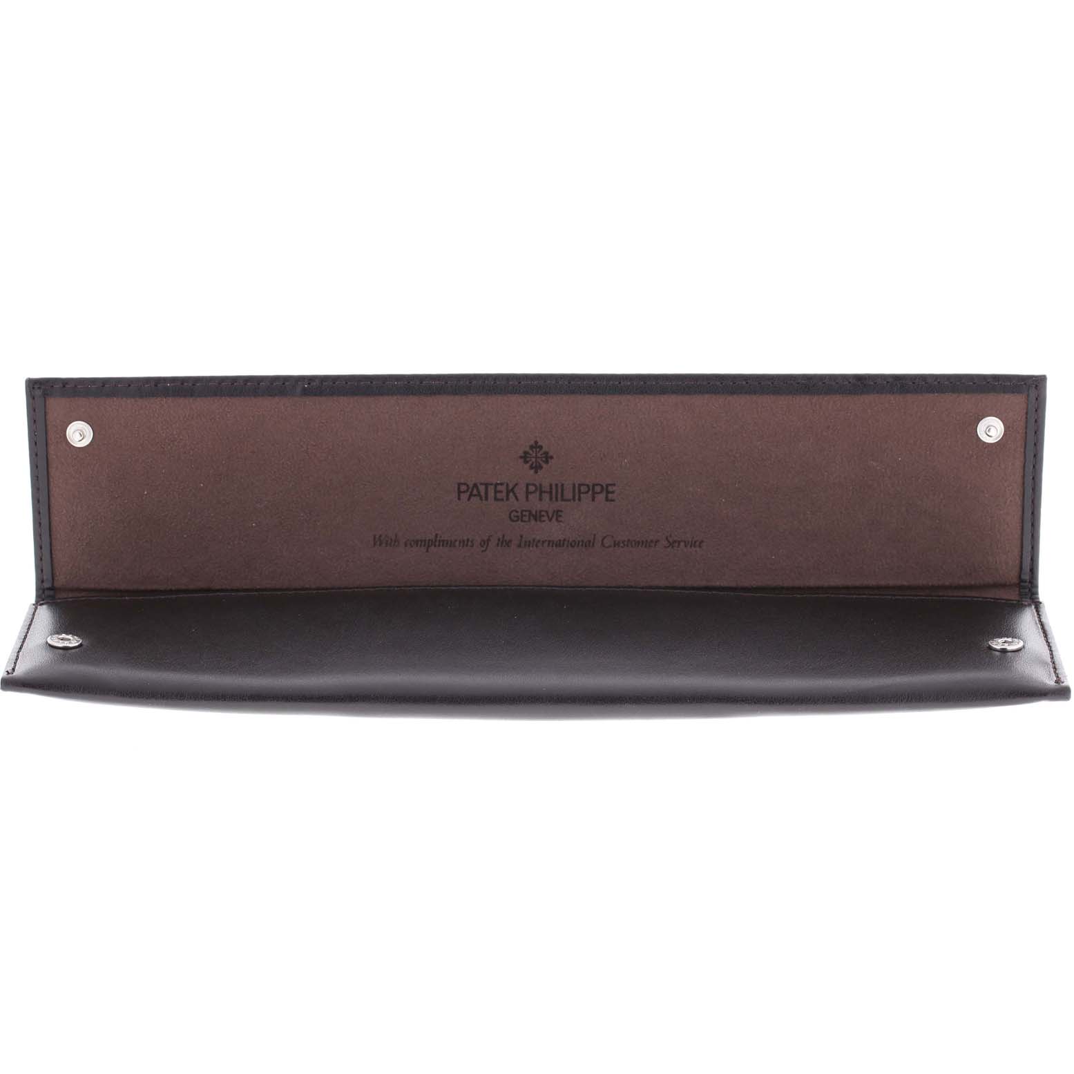 A Patek Philippe watch case opened to show its inner side displaying the brand name and logo.