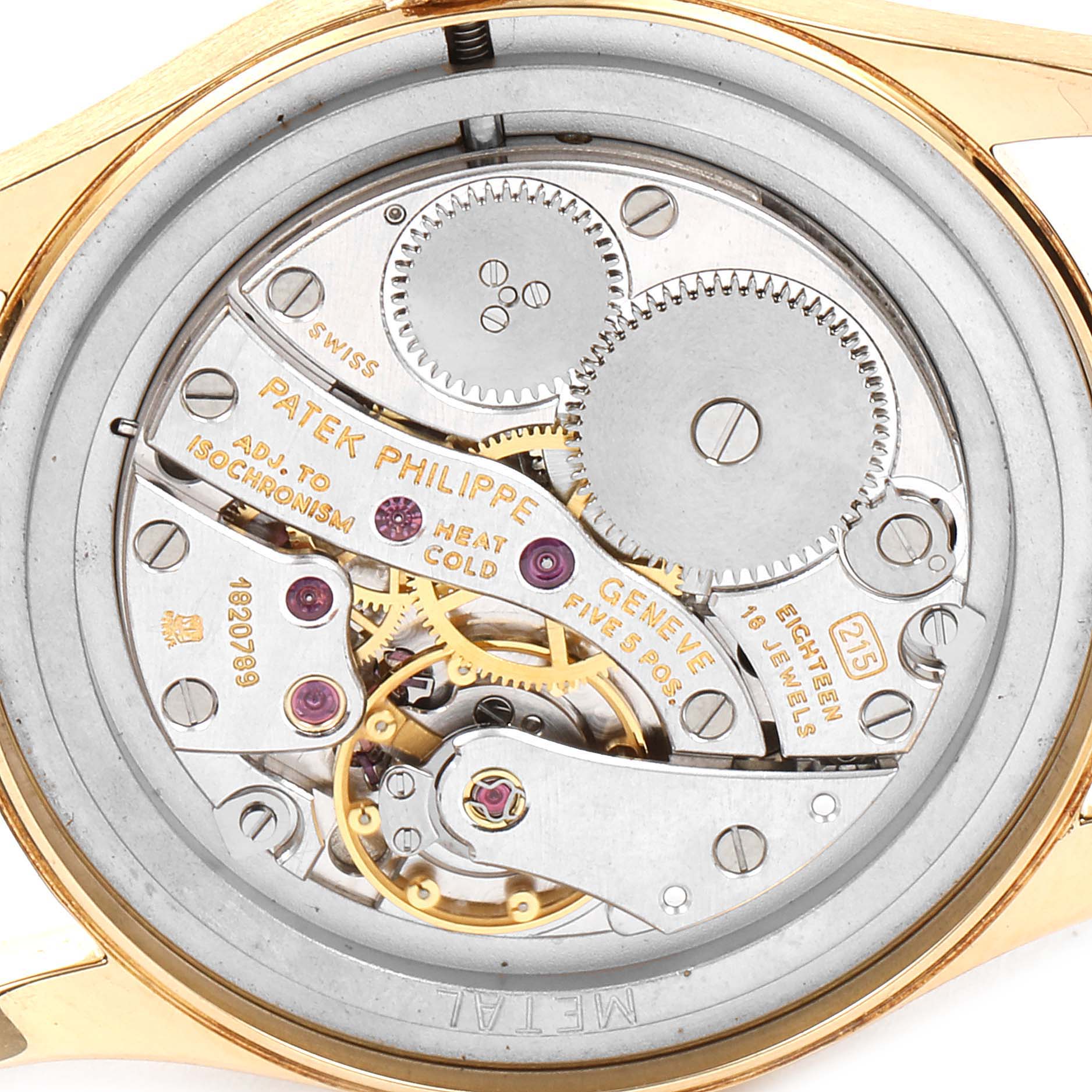 The image shows the open case back of a Vintage Patek Philippe watch, revealing its intricate mechanical movement.