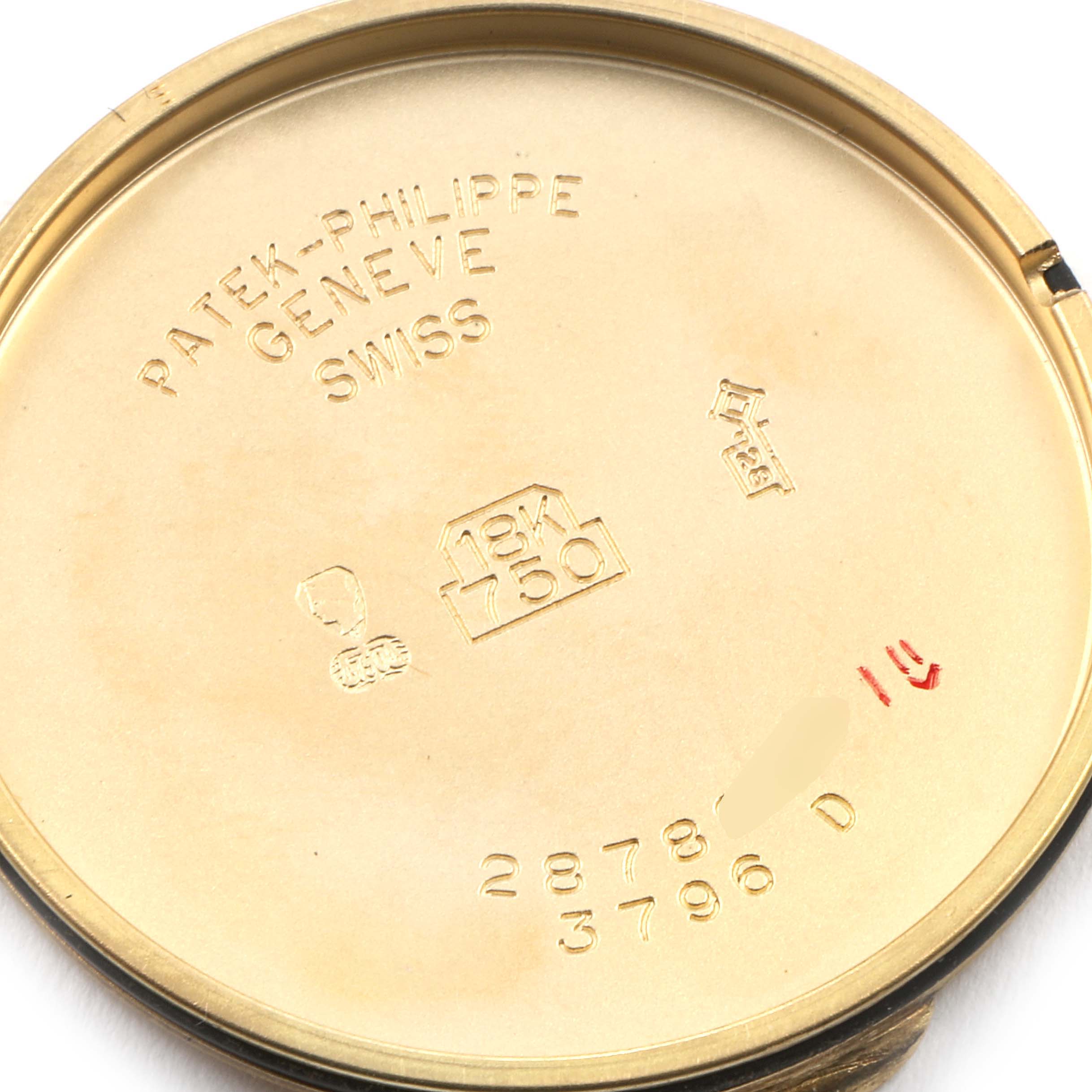 This image shows the inner case back of a vintage Patek Philippe watch, displaying brand markings and inscriptions.
