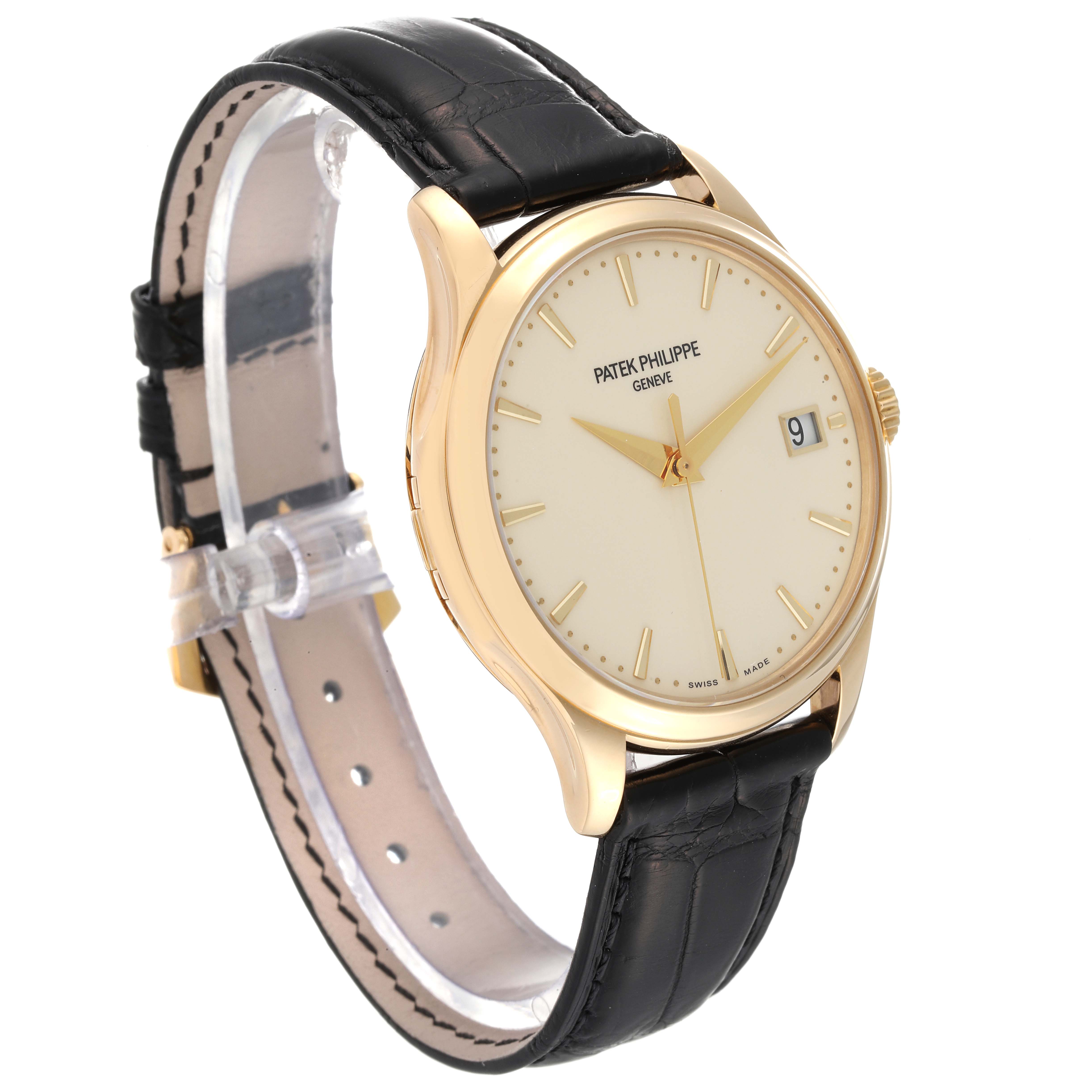 The image shows a Patek Philippe Calatrava 5227J-001 Men's Yellow Gold Beige Dial 5227J-001 Men's Yellow Gold Beige Dial watch angled from the front-left, displaying the dial, case, crown, and black leather strap.