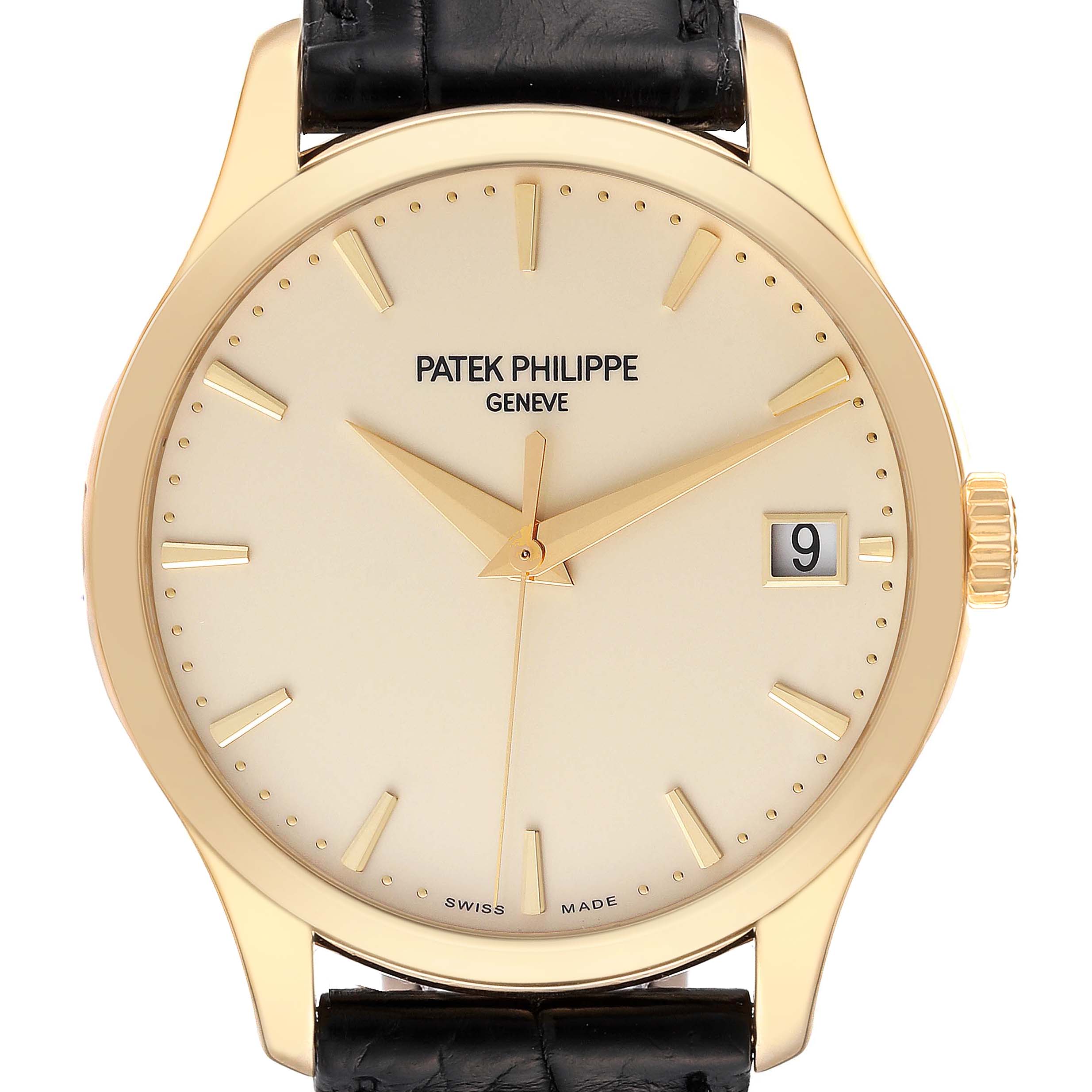 The watch is a Patek Philippe Calatrava 5227J-001 Men's Yellow Gold Beige Dial 5227J-001 Men's Yellow Gold Beige Dial model shown from a front angle, displaying the dial, hands, date window, and part of the strap.