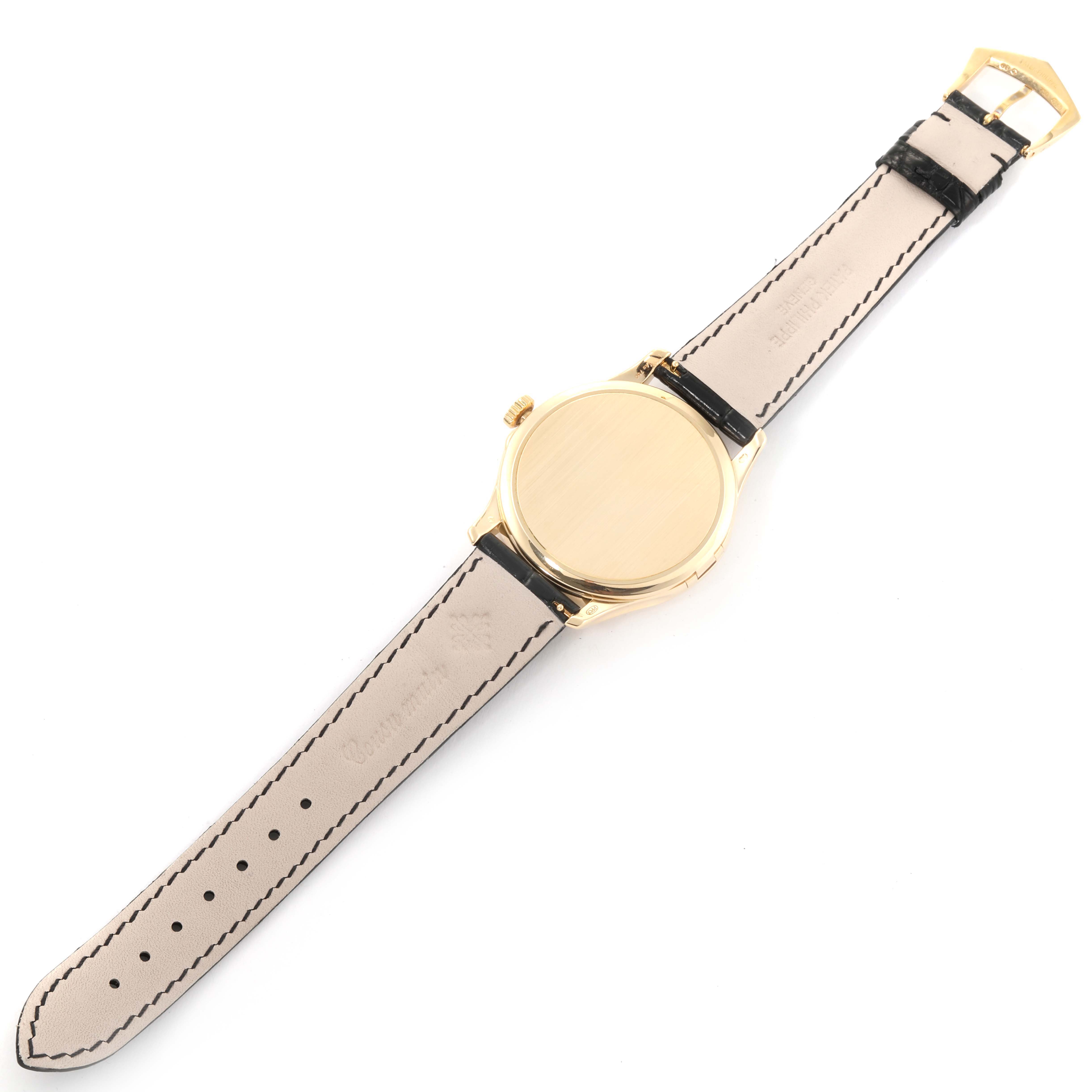 This image shows the back and strap of a Patek Philippe Calatrava 5227J-001 Men's Yellow Gold Beige Dial 5227J-001 Men's Yellow Gold Beige Dial model watch, viewed from a top-down angle.