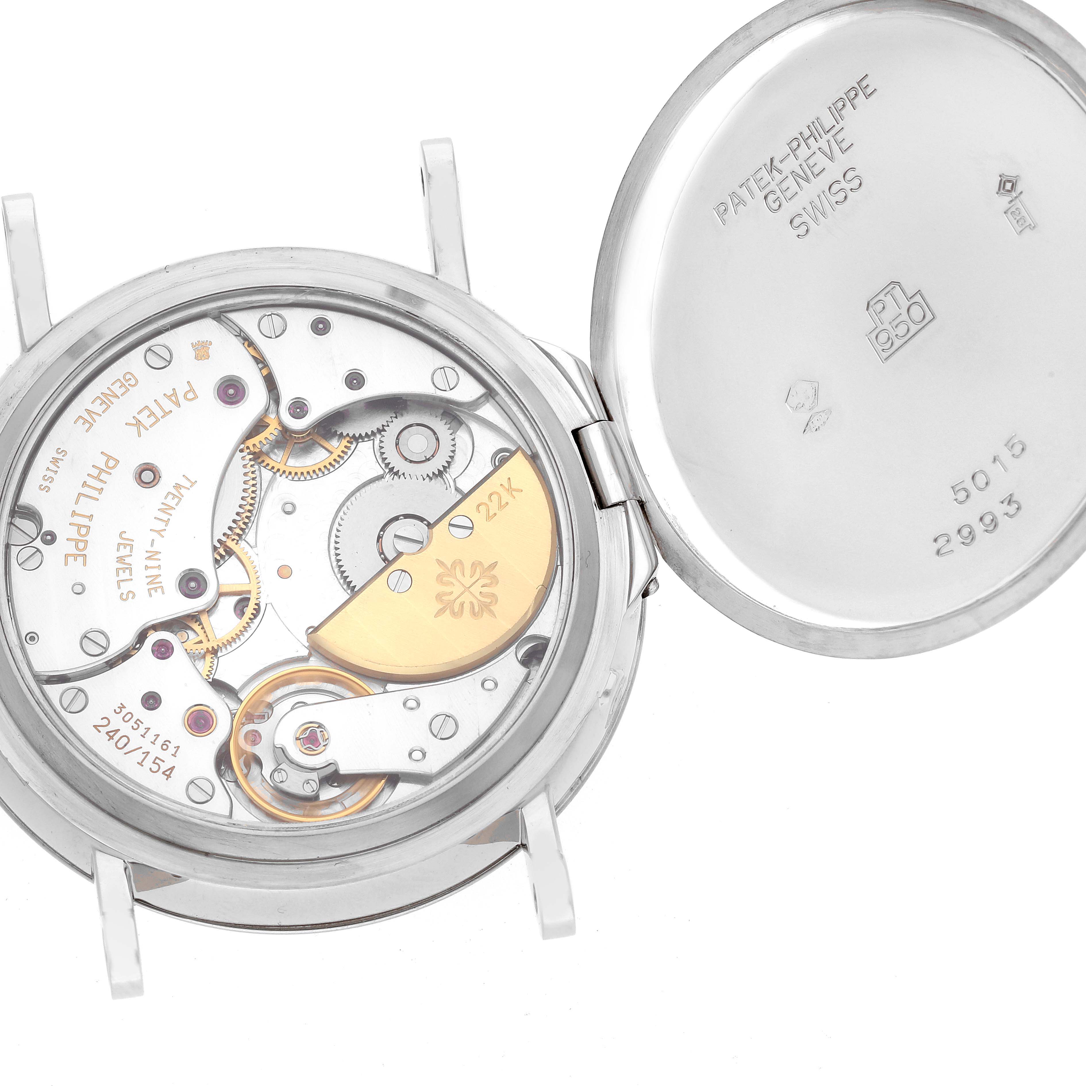 The image shows the intricate internal mechanism of a Patek Philippe Complications 5015 Men's Platinum White Dial 5015 Men's Platinum White Dial watch with the case back open.