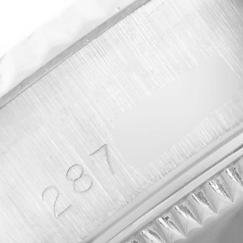 This image shows a close-up of the serial number engraving on the side of a Rolex Date 6917 Women's Stainless Steel Blue Dial 6917 Women's Stainless Steel Blue Dial model watch case.