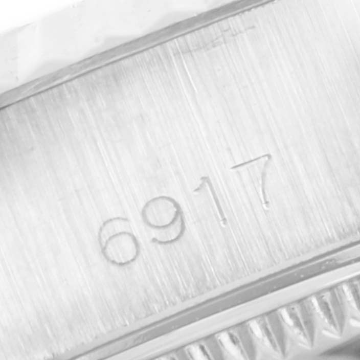 The image shows a close-up of the case back engraving with the model number "6917" on a Rolex Date 6917 Women's Stainless Steel Blue Dial 6917 Women's Stainless Steel Blue Dial watch.