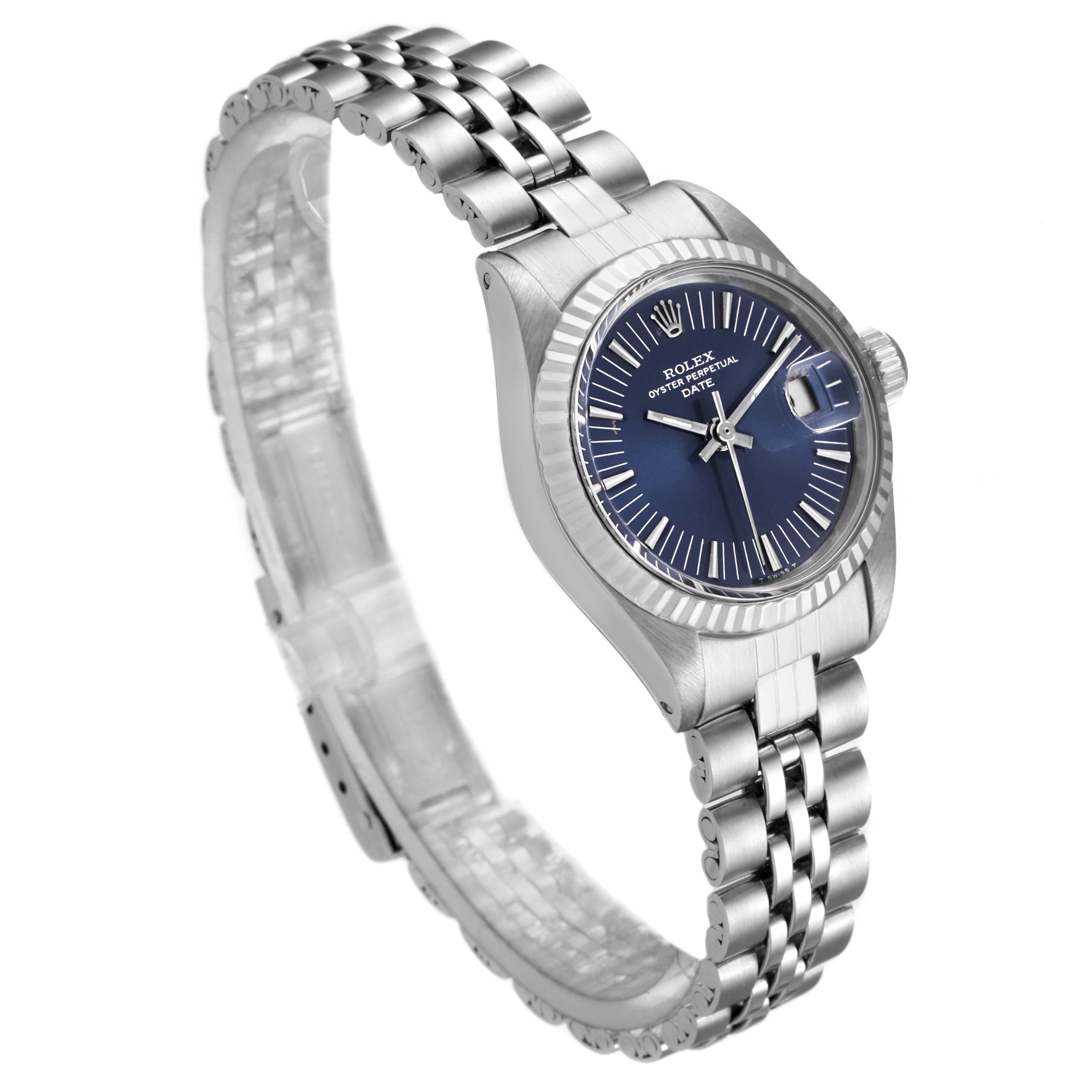 The Rolex Date 6917 Women's Stainless Steel Blue Dial 6917 Women's Stainless Steel Blue Dial watch is shown at an angled view, displaying its blue dial, fluted bezel, and stainless steel jubilee bracelet.