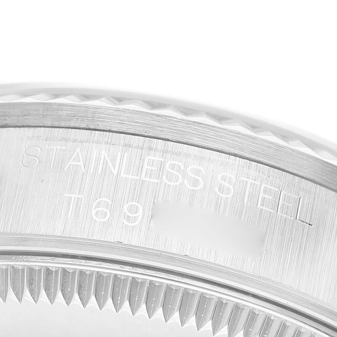 The image shows a close-up of the side view of a Rolex Mid-Size 68274 Women's Stainless Steel Black Dial model's stainless steel watch case with engraved markings.