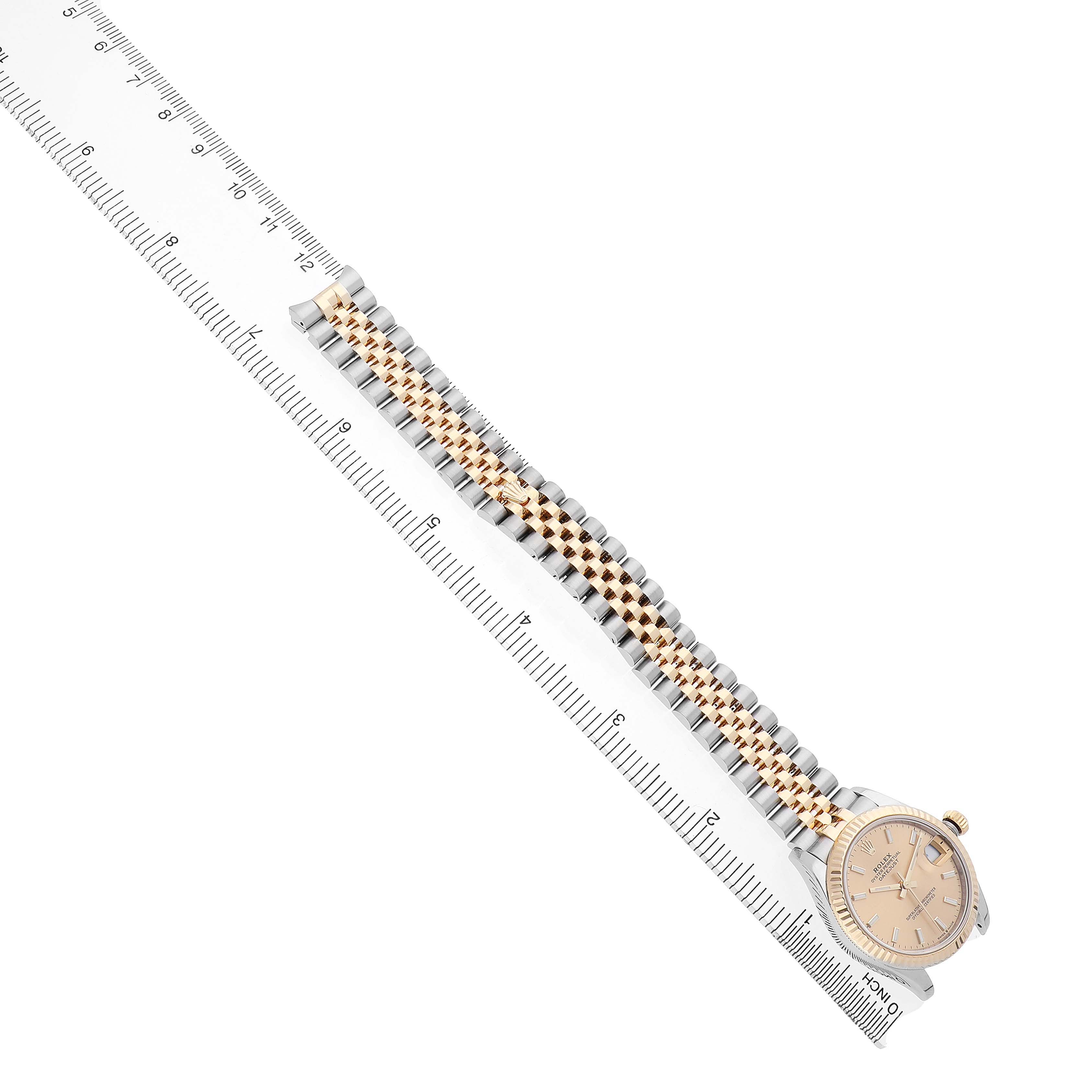 The Rolex Datejust 278273 Men's Steel and Gold (two tone) Champagne Dial watch is shown from an overhead angle with its dial and full bracelet visible, next to a ruler.