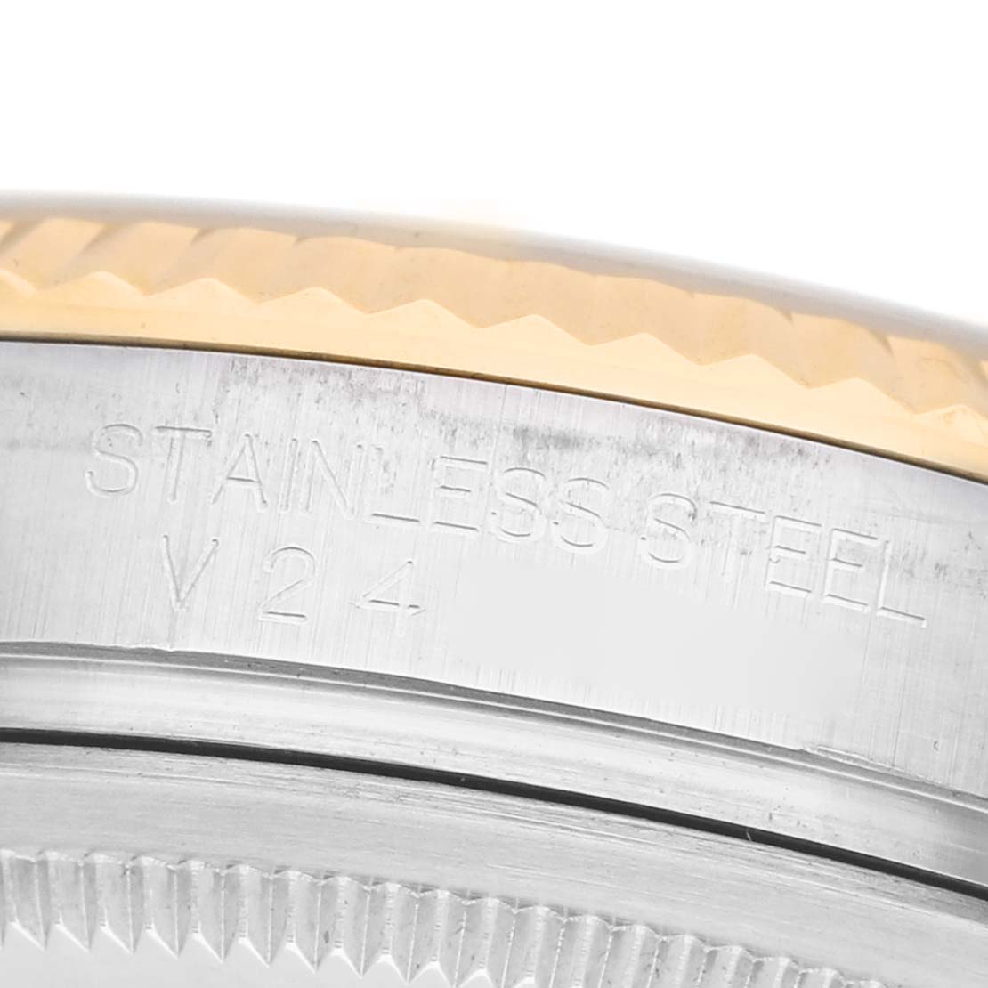 The image shows a close-up of the Rolex Datejust 116233 Men's Stainless Steel Champagne Dial bezel and case, highlighting the stainless steel engraving.