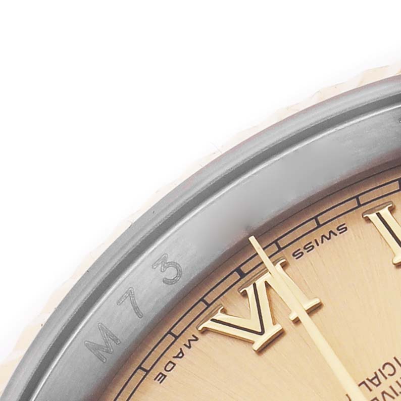 The image shows a close-up of a Rolex Datejust 116233 Men's Stainless Steel Champagne Dial, focusing on the dial's edge, Roman numerals, and case with engraved text.