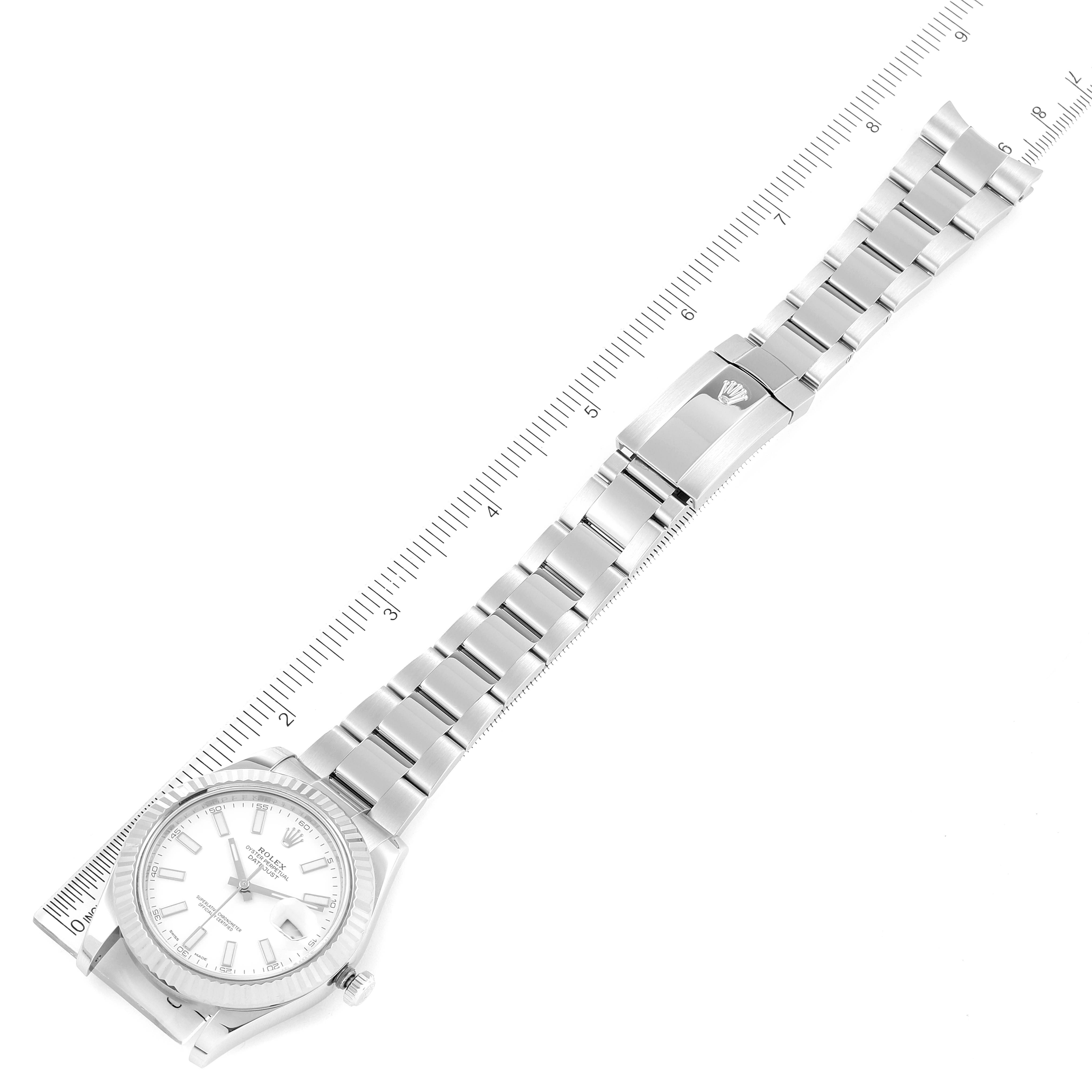 The image shows a top-down view of a Rolex Datejust 41 116334 Men's Stainless Steel White Dial 116334 Men's Stainless Steel White Dial model watch, including its face and full bracelet alongside a measurement ruler.
