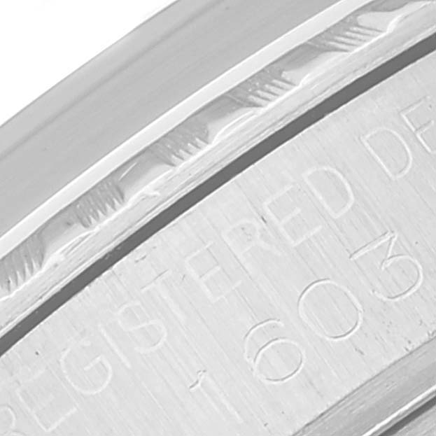 This image shows a close-up of the engraved inscription on the inner bezel of a Rolex Datejust 1603 Men's Stainless Steel Silver Dial 1603 Men's Stainless Steel Silver Dial watch.