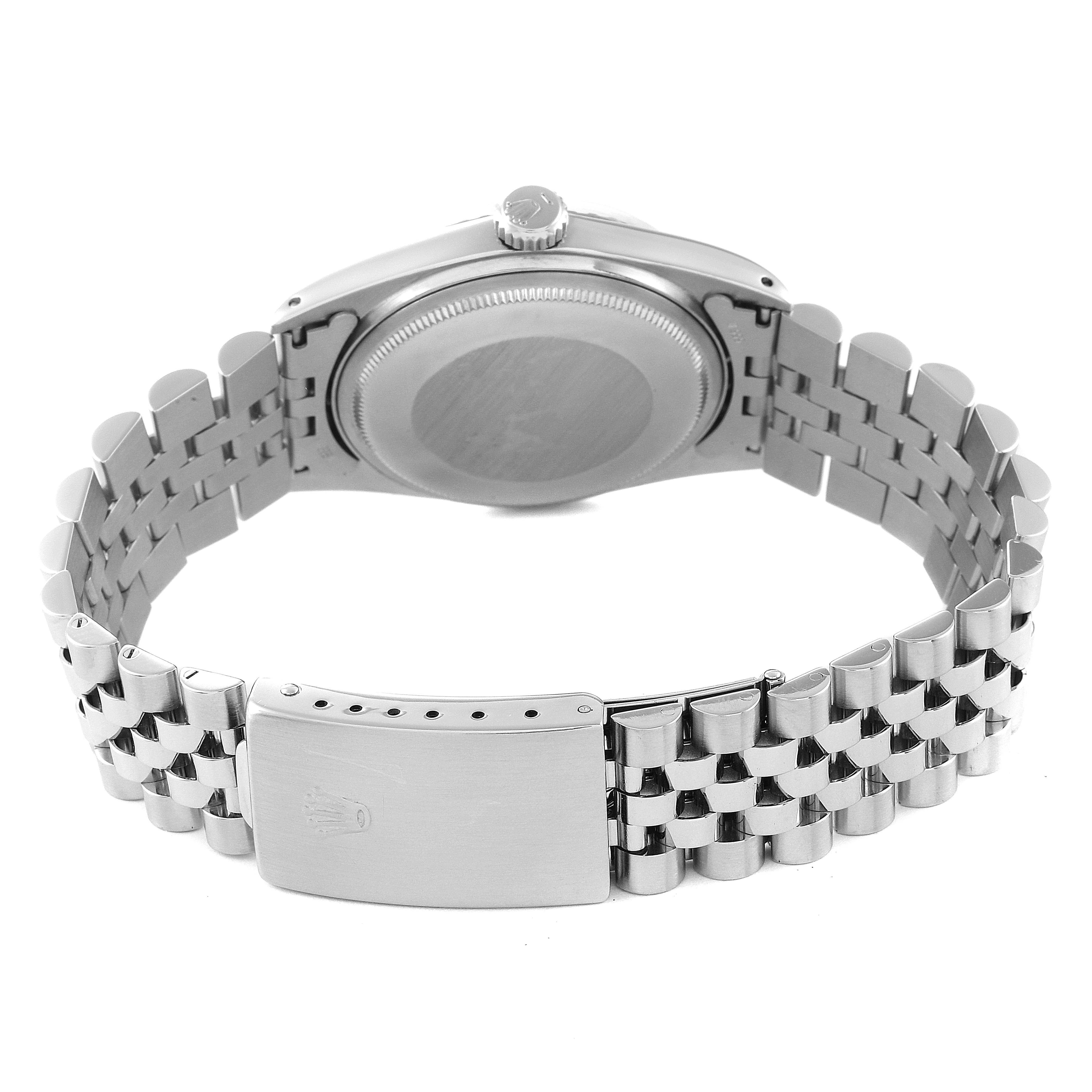 The image shows the back view of a Rolex Vintage Collection 1603 Men's Stainless Steel Silver Dial 1603 Men's Stainless Steel Silver Dial watch, highlighting its stainless steel case, crown, and bracelet with a clasp.