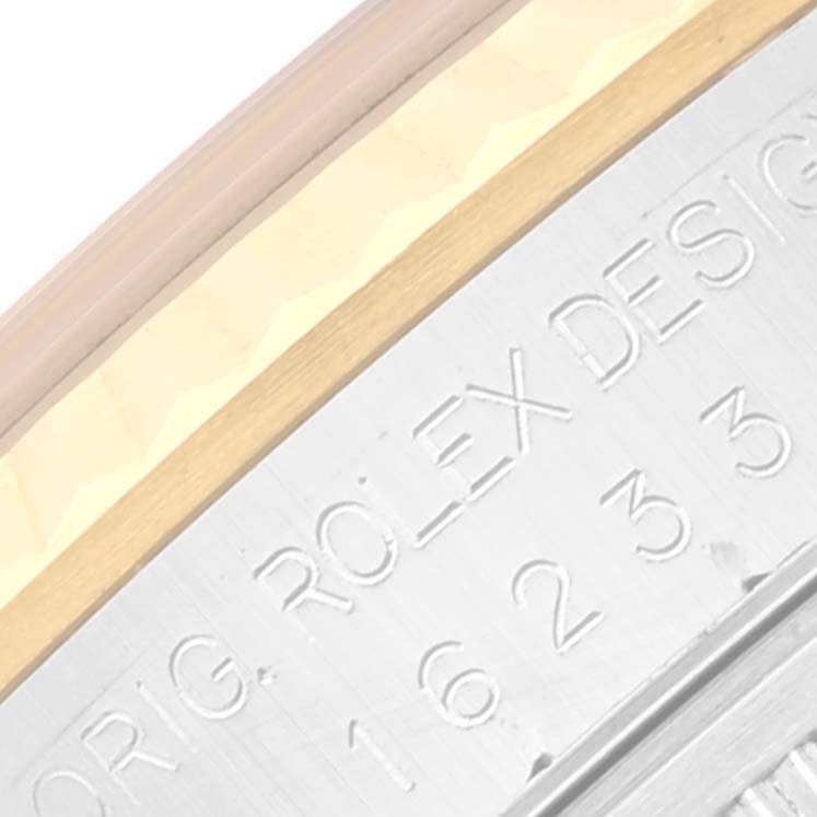 The image shows a close-up of the engraved side of a Rolex Datejust 16233 Men's Steel and Gold (two tone) Mother of Pearl Dial 16233 Men's Steel and Gold (two tone) Mother of Pearl Dial watch case with visible text.