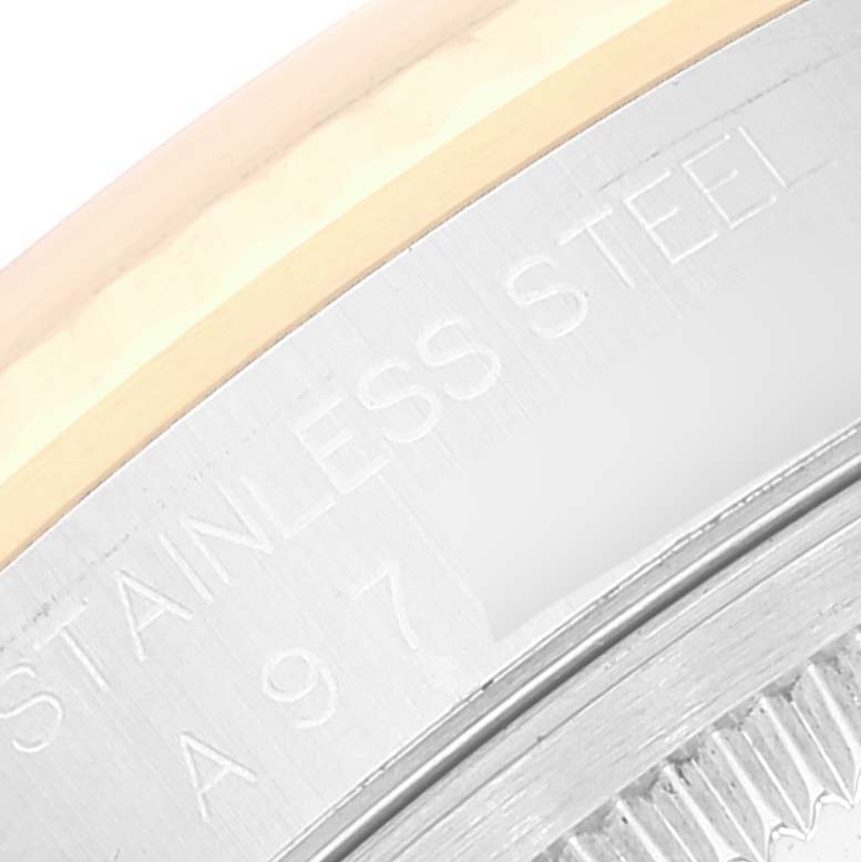 The image shows a close-up of the engraved stainless steel and gold bezel of a Rolex Datejust 16233 Men's Steel and Gold (two tone) Mother of Pearl Dial 16233 Men's Steel and Gold (two tone) Mother of Pearl Dial watch.