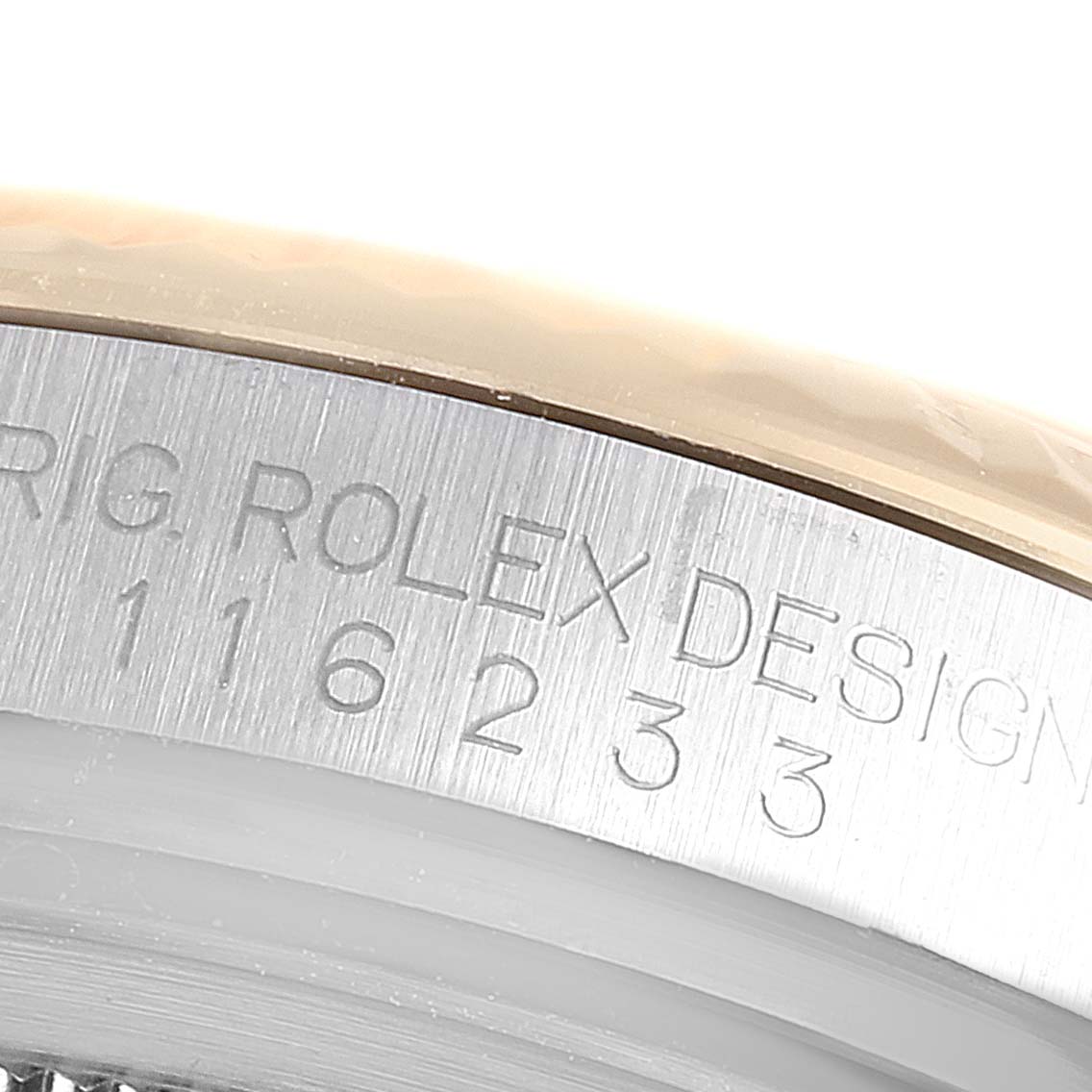 The image shows a close-up of the outer edge of a Rolex Datejust 116233 Men's Steel and Gold (two tone) White Dial 116233 Men's Steel and Gold (two tone) White Dial model watch, highlighting the engraving on the case.