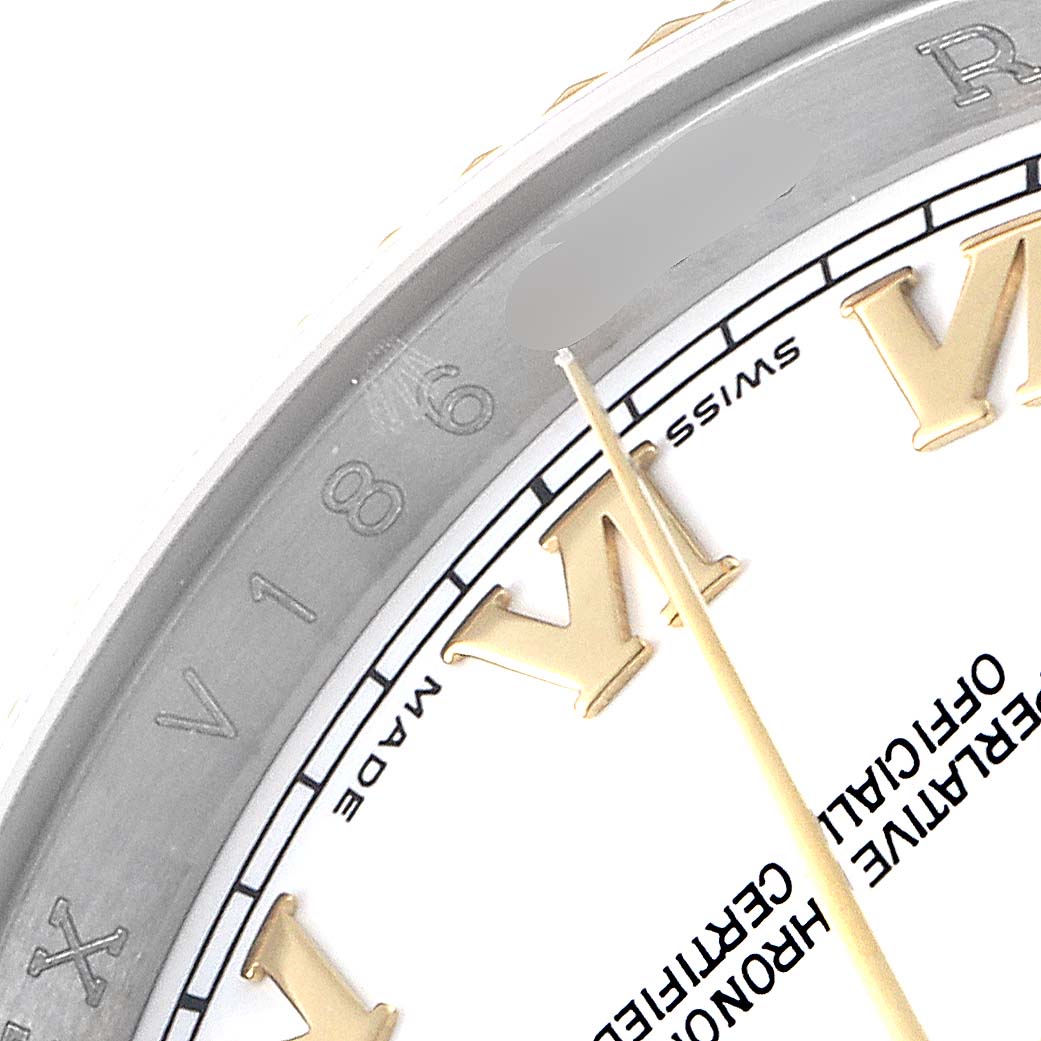The image shows a close-up of the dial and bezel of a Rolex Datejust 116233 Men's Steel and Gold (two tone) White Dial 116233 Men's Steel and Gold (two tone) White Dial, focusing on the Roman numeral hour markers and the seconds hand.