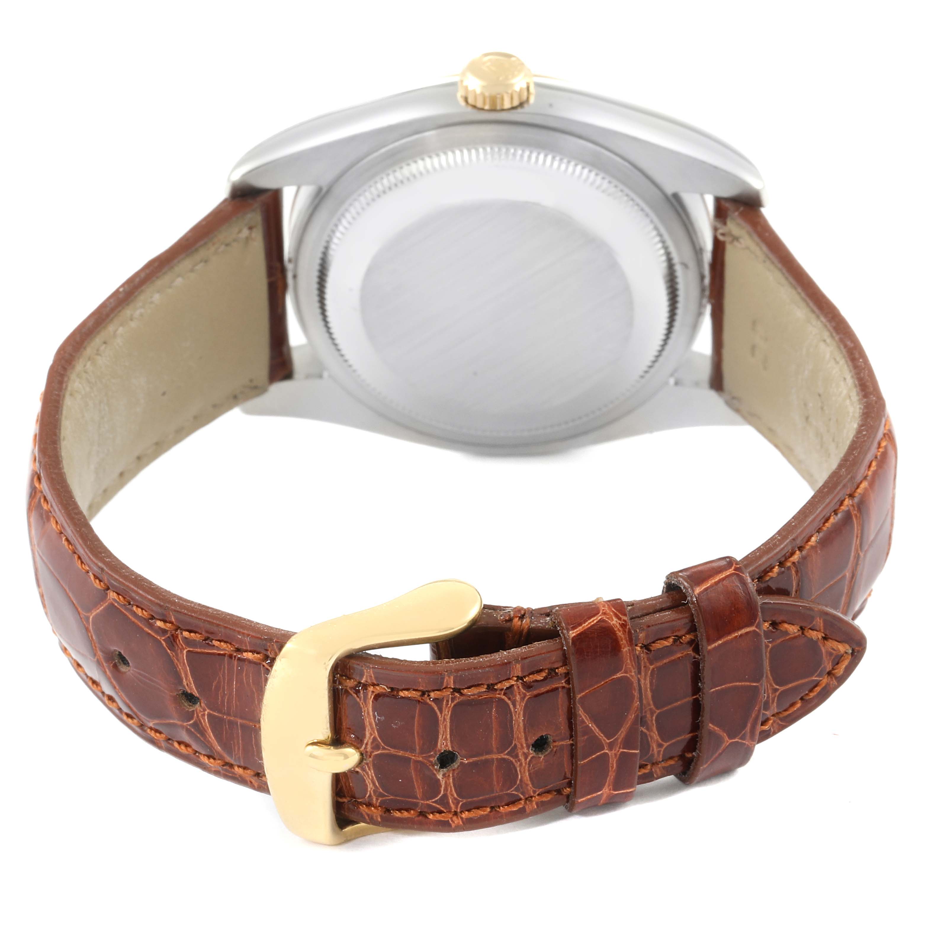 The image shows the back view of a Rolex Datejust 116233 Men's Steel and Gold (two tone) White Dial 116233 Men's Steel and Gold (two tone) White Dial watch, highlighting its case and leather strap with a gold buckle.