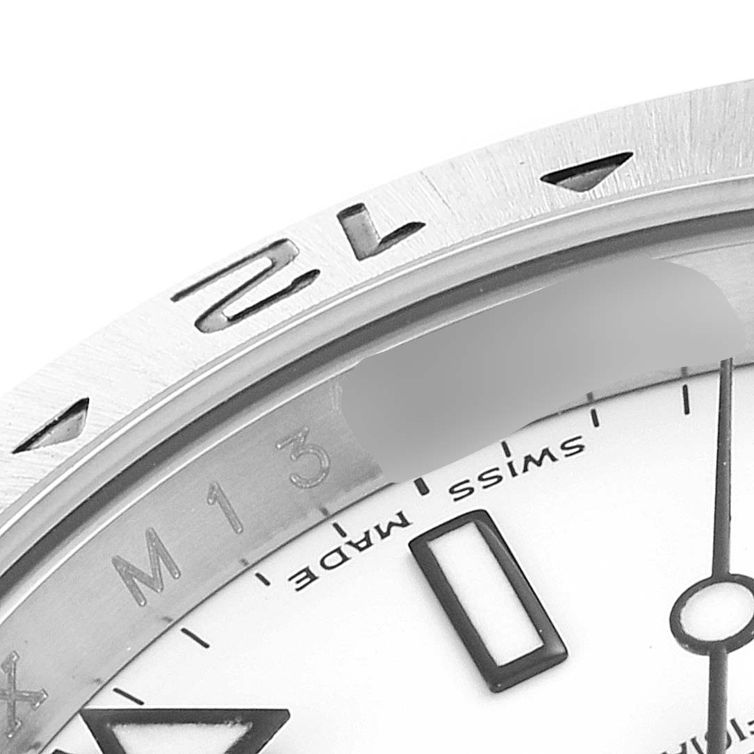 The image shows a close-up of the bezel and part of the dial of a Rolex Explorer 16570 Men's Stainless Steel White Dial 16570 Men's Stainless Steel White Dial watch, highlighting the "Swiss Made" text.