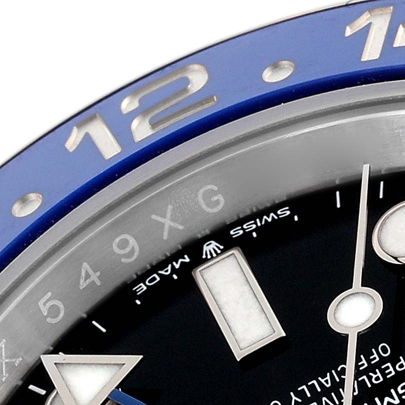 This image shows a close-up of the dial and bezel of a Rolex GMT-Master 126710 Men
s Stainless Steel Black Dial 126710 Men
s Stainless Steel Black Dial watch, focusing on the 12 o
clock marker.
