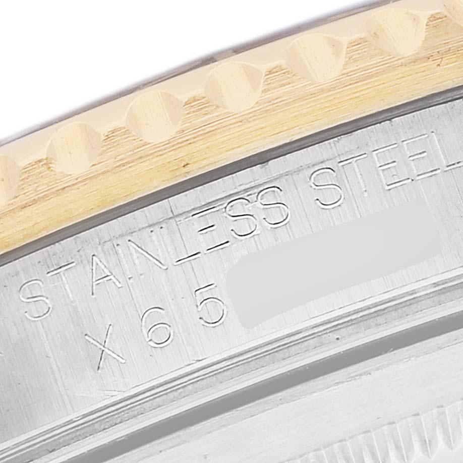 This image shows a close-up of the side engraving on a Rolex GMT-Master 16713 Men's Steel and Gold (two tone) Champagne Dial 16713 Men's Steel and Gold (two tone) Champagne Dial watch, highlighting the text "STAINLESS STEEL."