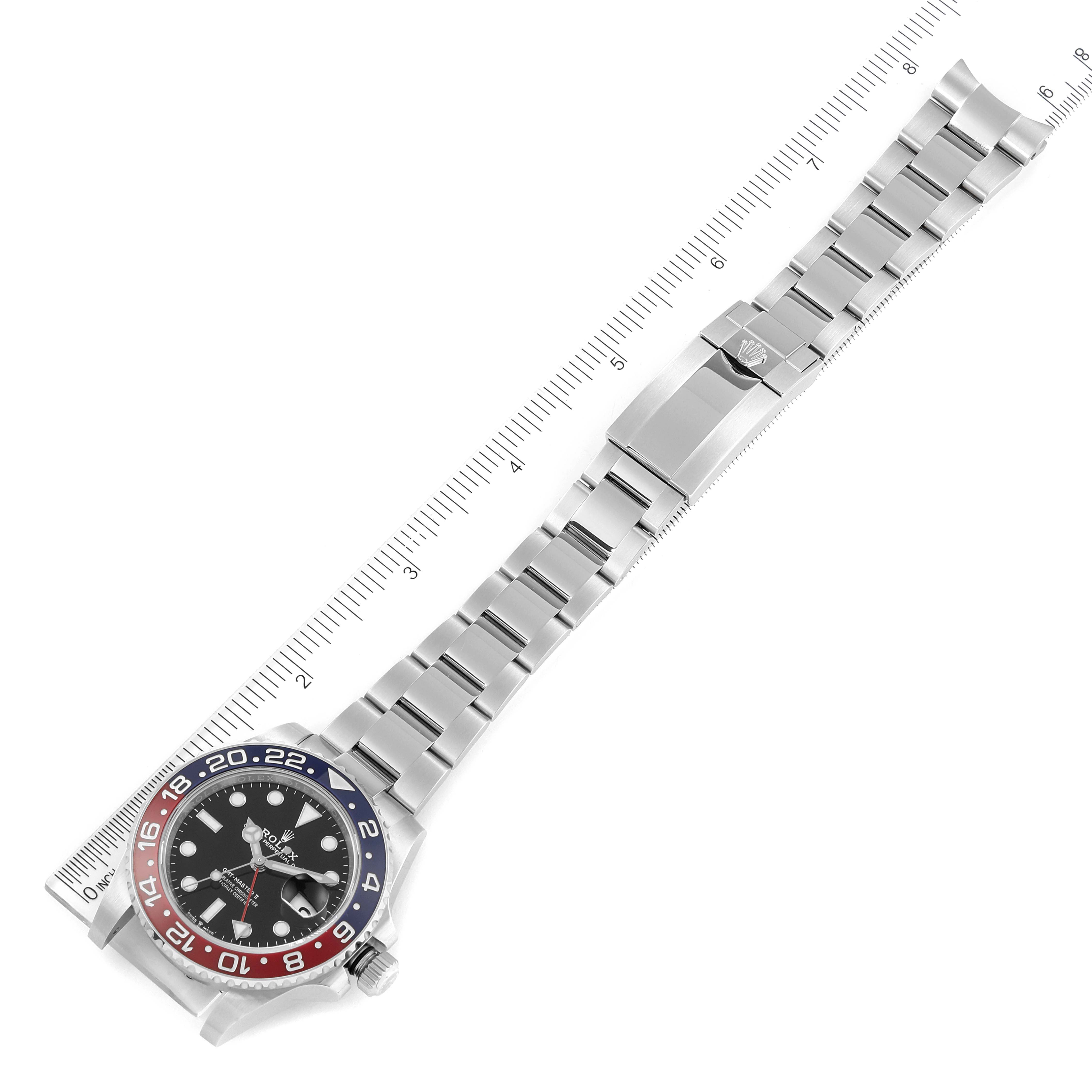 The Rolex GMT-Master 126710BLRO Men
s Stainless Steel Black Dial 126710BLRO Men
s Stainless Steel Black Dial watch is shown from an angled top view, displaying the face, bezel, and full bracelet with a ruler for scale.