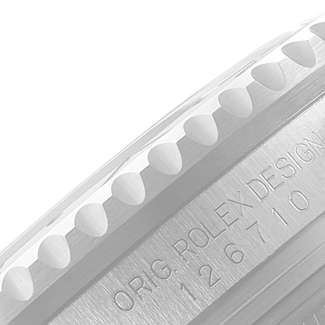 The image shows a close-up of the side of a Rolex GMT-Master 126710BLRO Men
s Stainless Steel Black Dial 126710BLRO Men
s Stainless Steel Black Dial watch, highlighting the bezel edge and engraving.