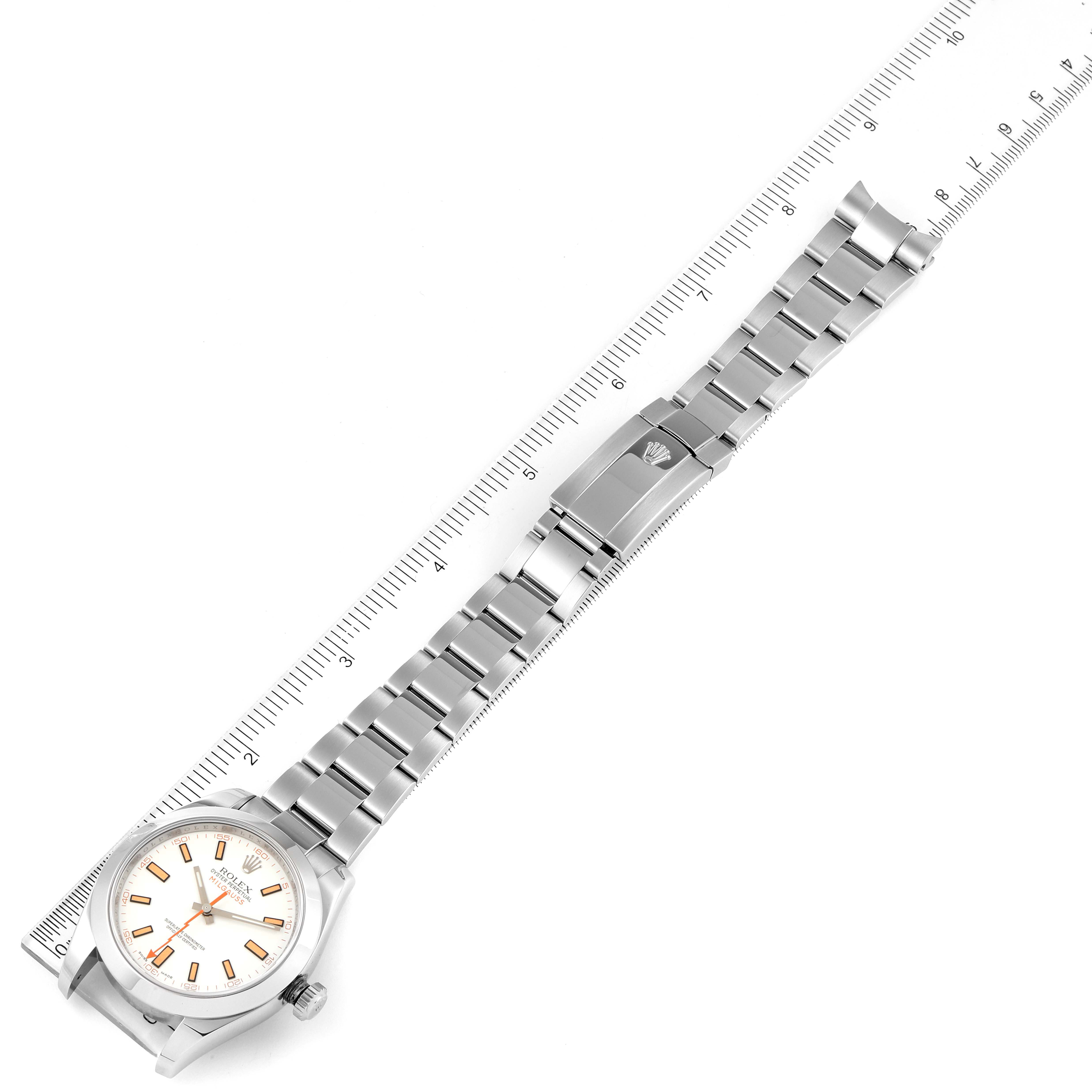 The image shows a Rolex Milgauss 116400V Men's Stainless Steel White Dial 116400V Men's Stainless Steel White Dial watch laid flat with its face and bracelet fully visible, next to a ruler for scale.